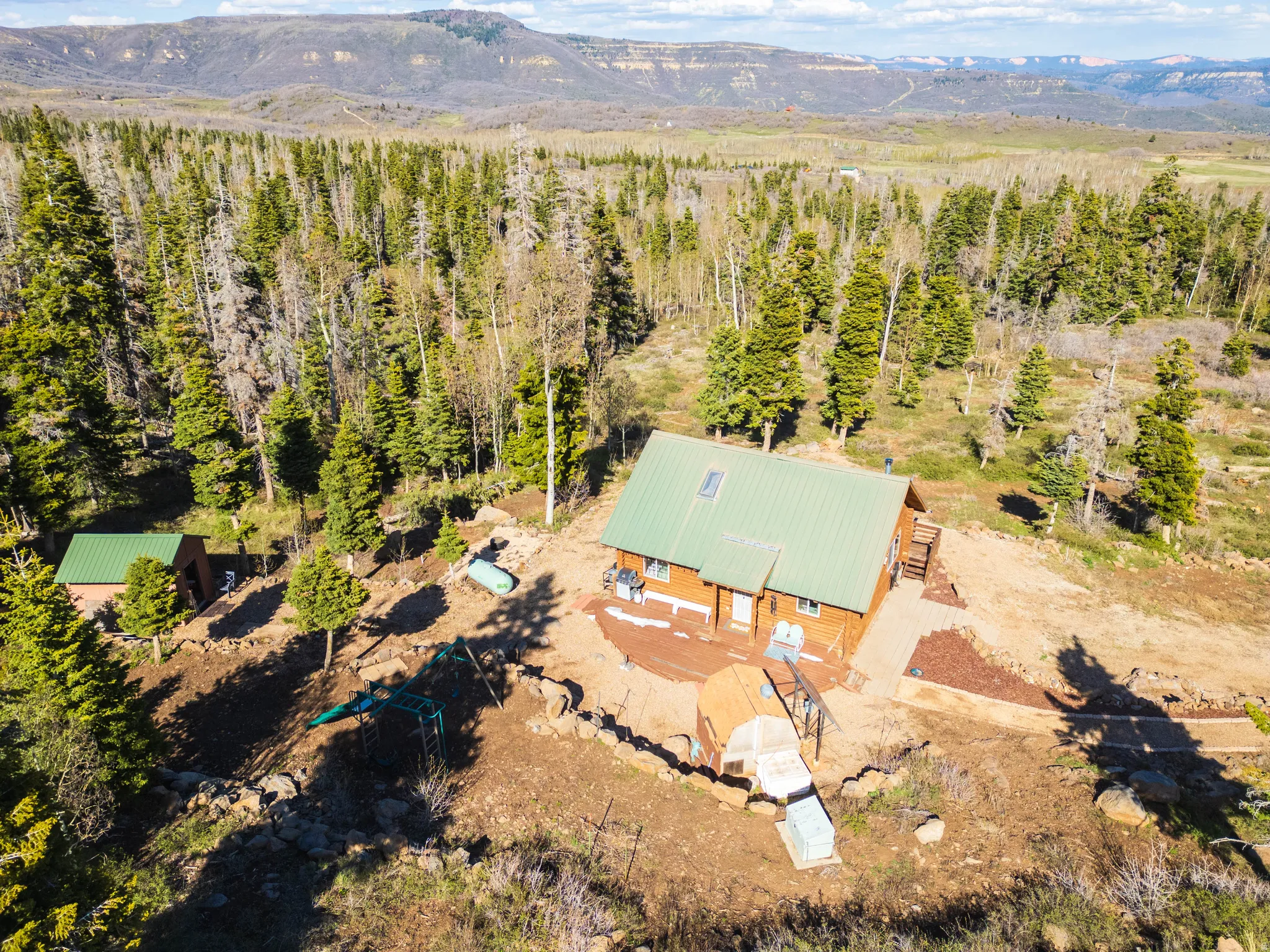 The Ultimate Getaway: Looking down at the cabin nestled safely in the mountain pines.