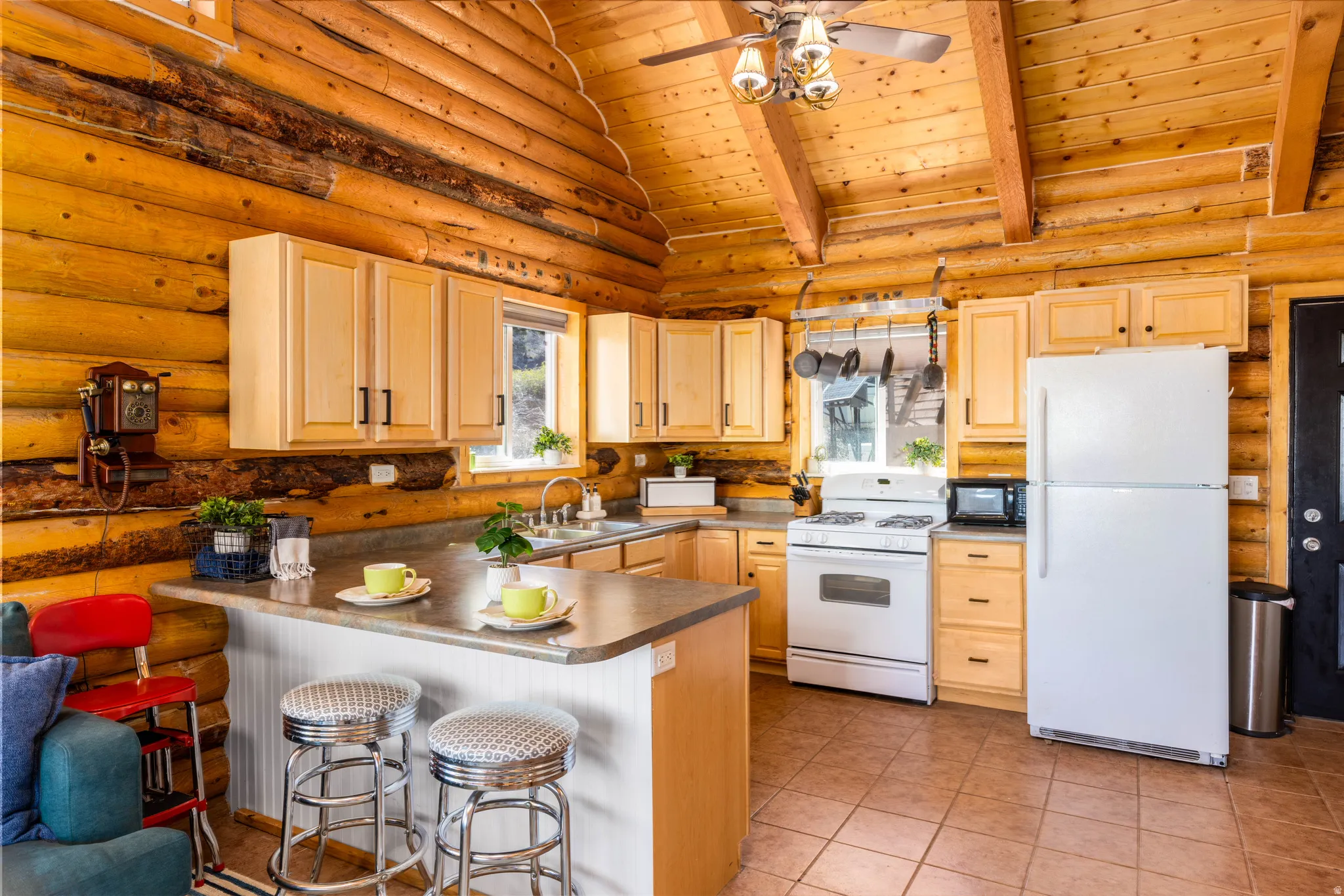 Gourmet Cabin Kitchen: Features custom cabinetry, ample counter space, and a convenient breakfast bar.