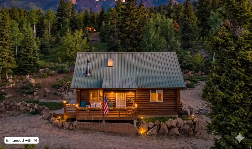 Twilight Mountain Retreat: A stunning evening view highlighting the warm, inviting glow of this secluded log home.