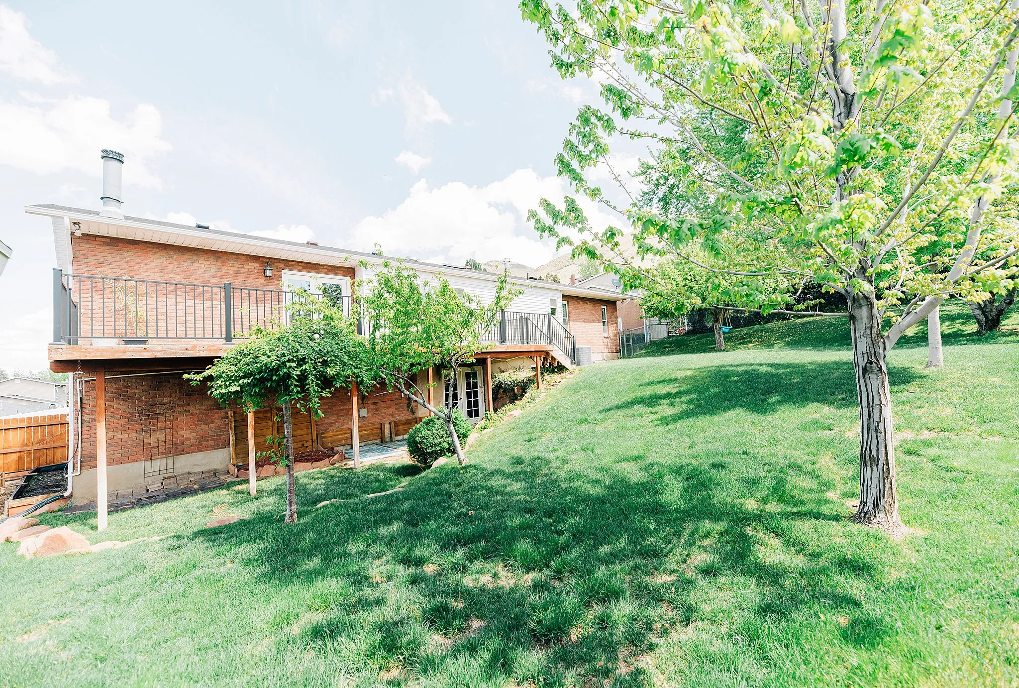 View of yard with a deck and stairs