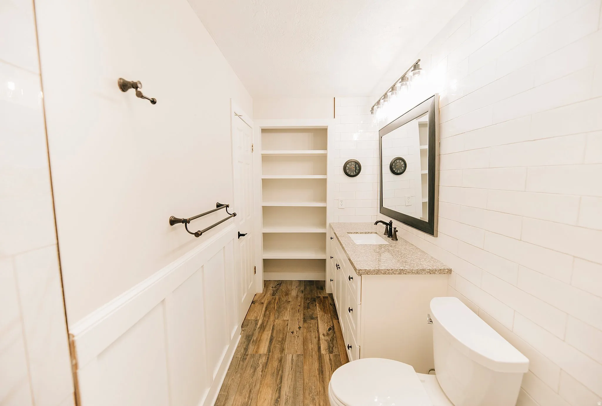 Full bathroom with vanity and light wood finished floors