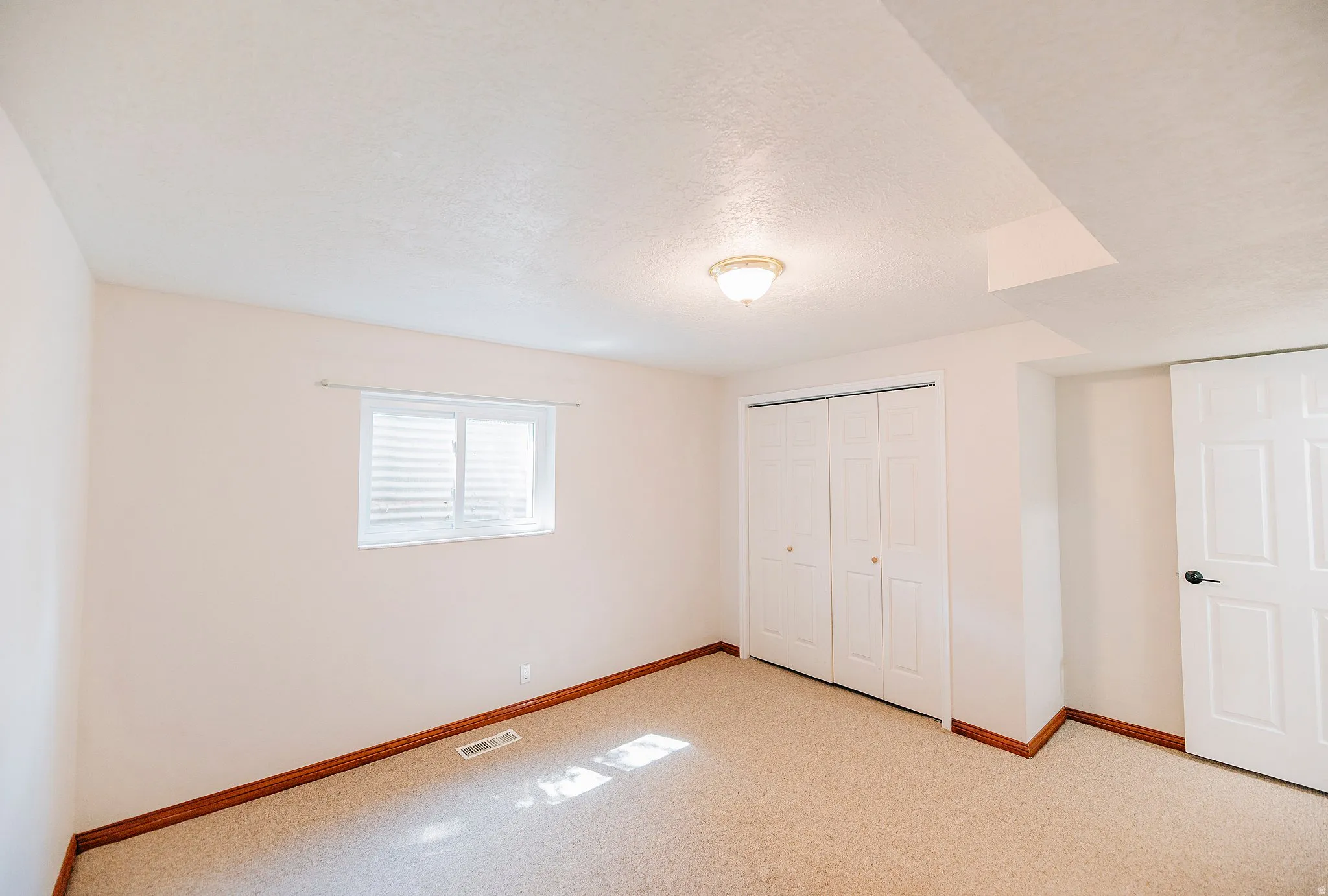 Unfurnished bedroom featuring a closet and a textured ceiling