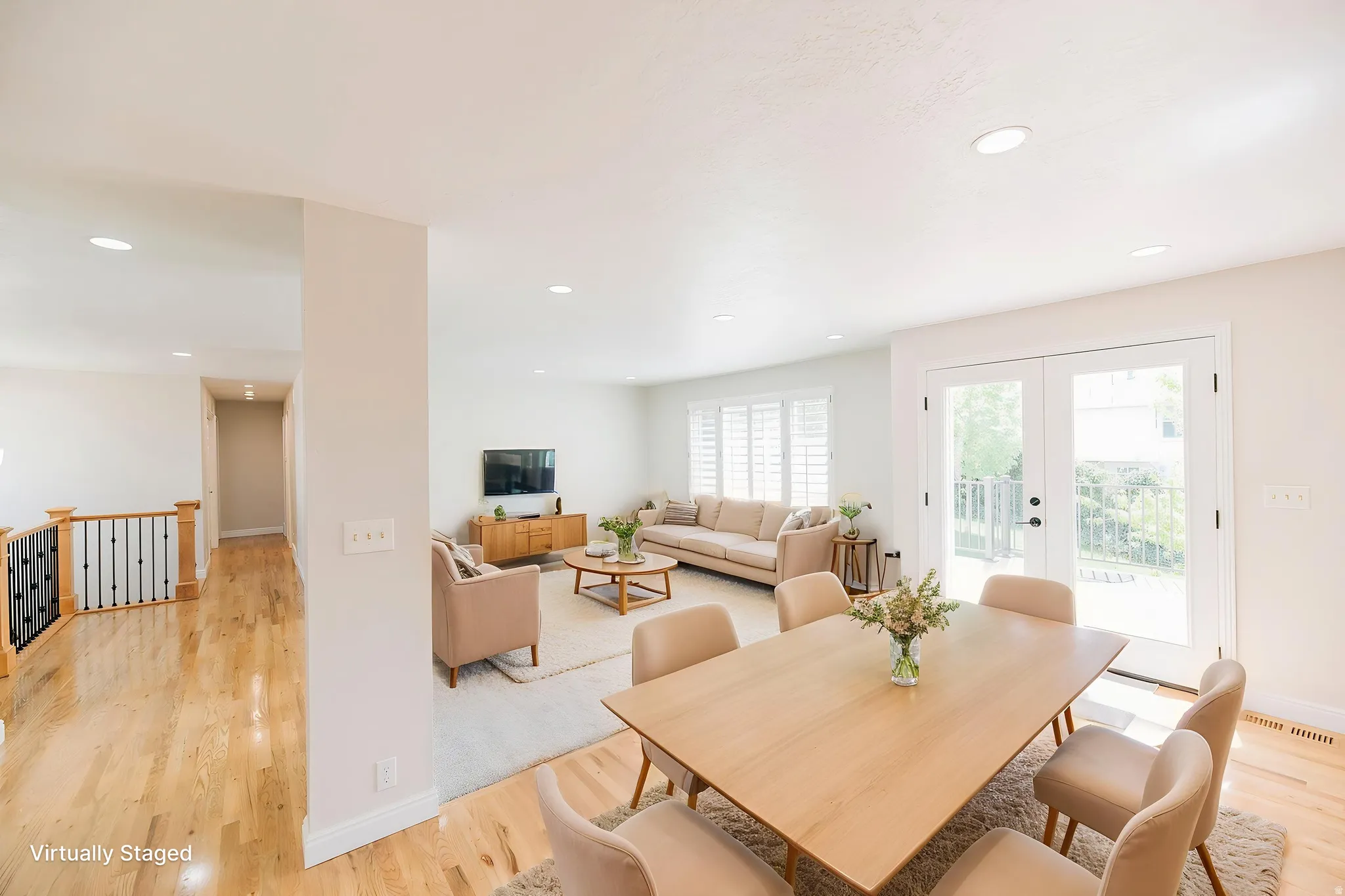 Dining space with french doors, light wood-type flooring, and recessed lighting