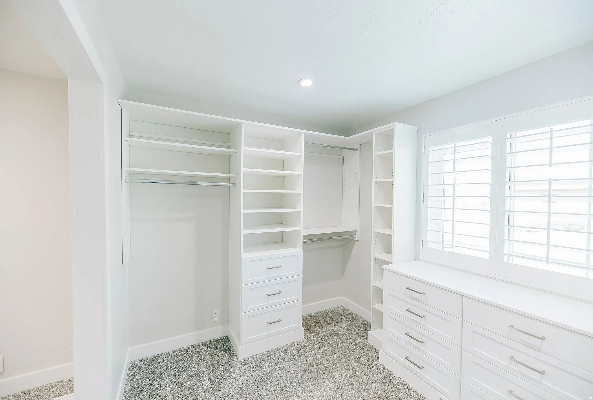 Walk in closet featuring light carpet