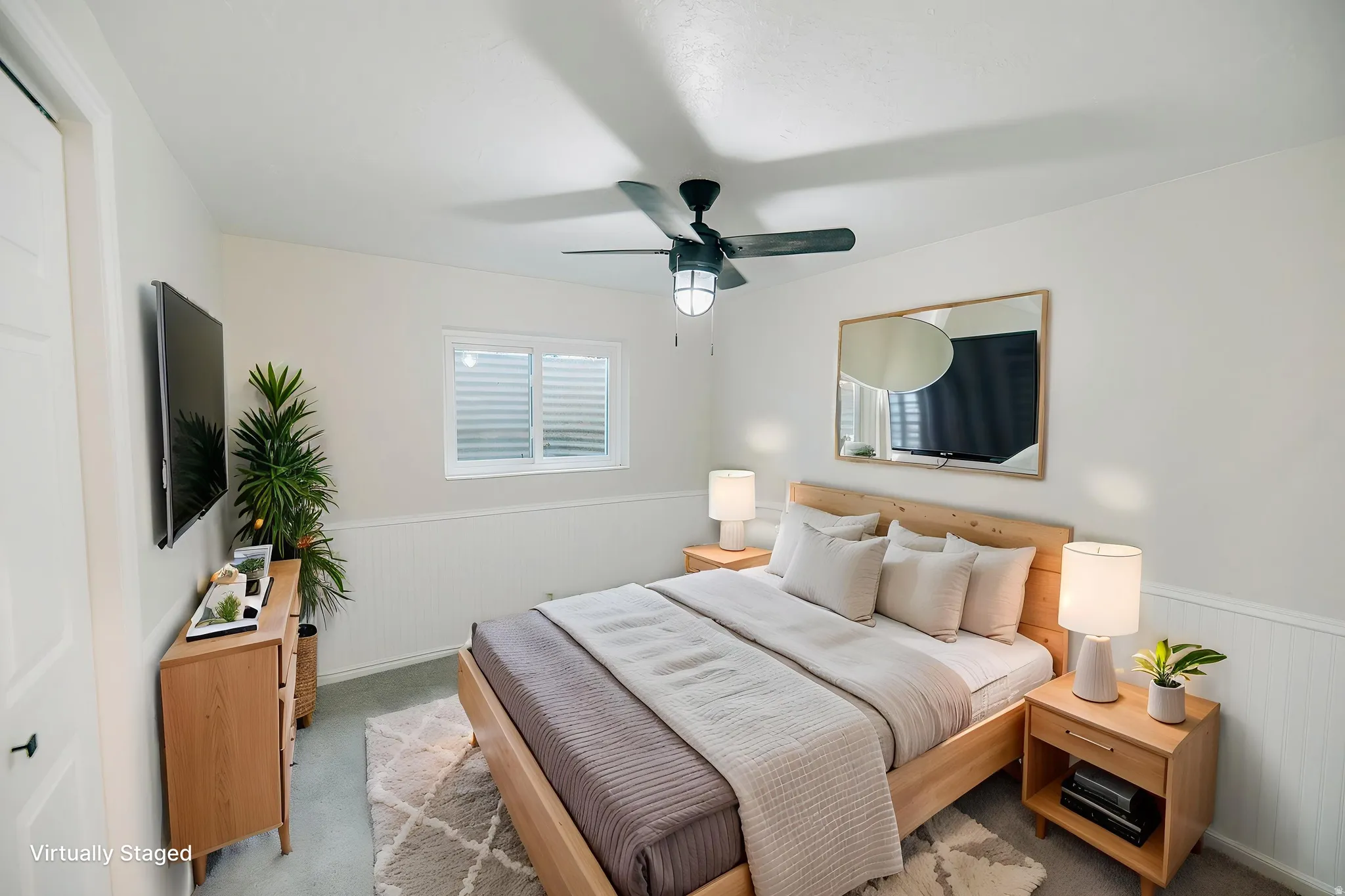 Bedroom with wainscoting and ceiling fan