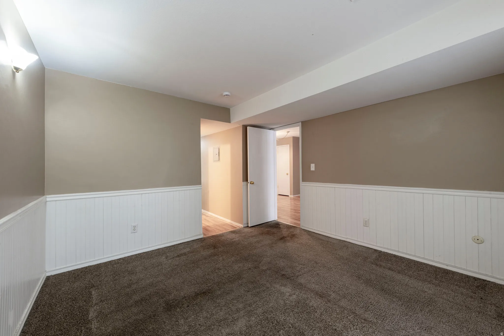 Bedroom without furniture and a wainscoted wall