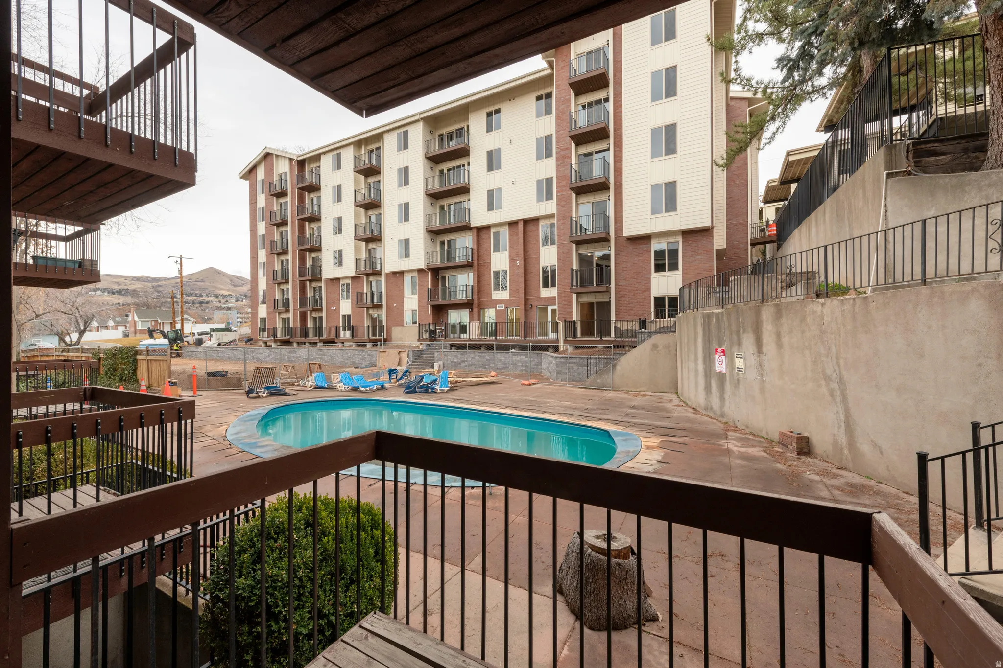 Community pool featuring a balcony and a mountain view