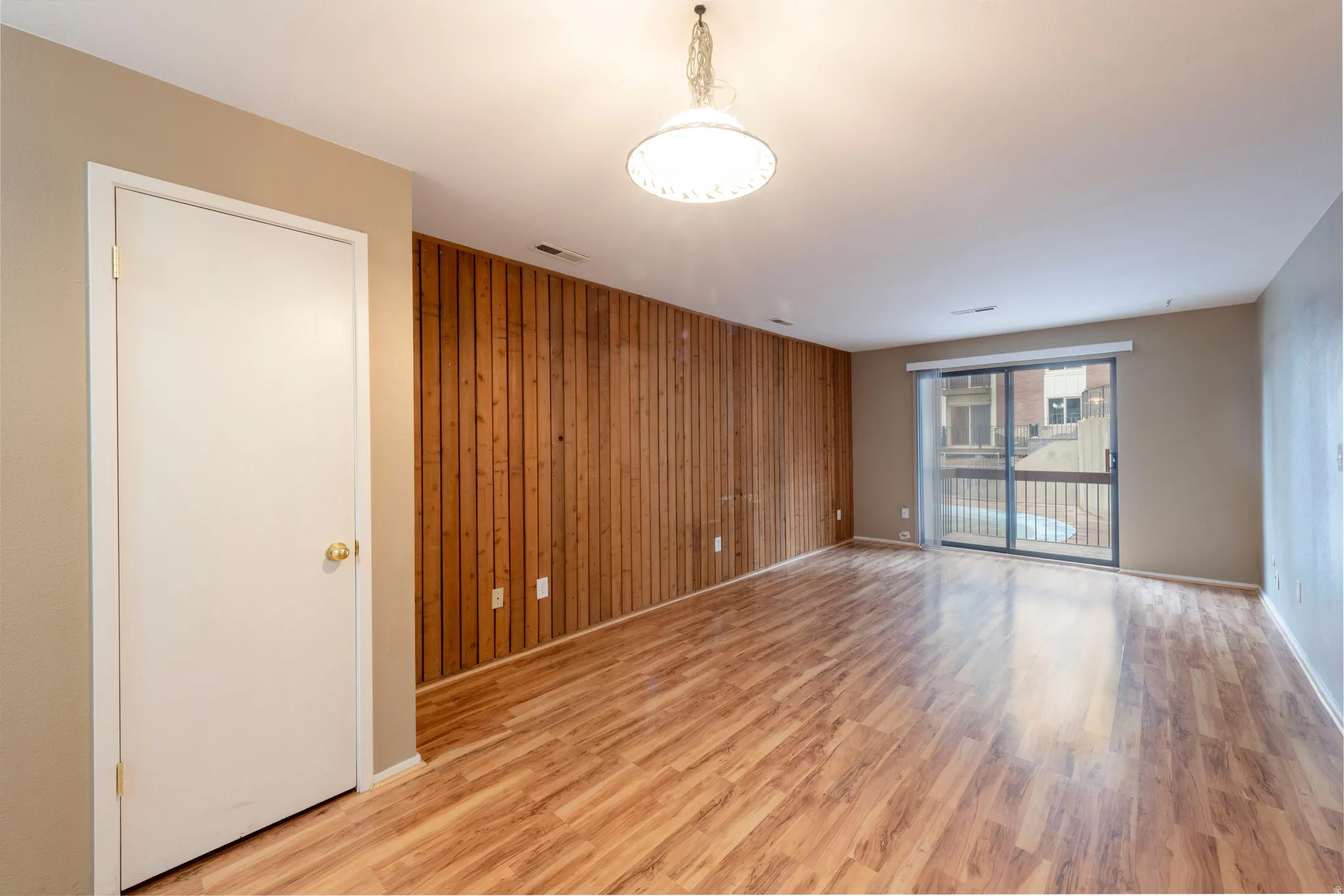 Living room featuring wooden accent wall and light wood finished floors