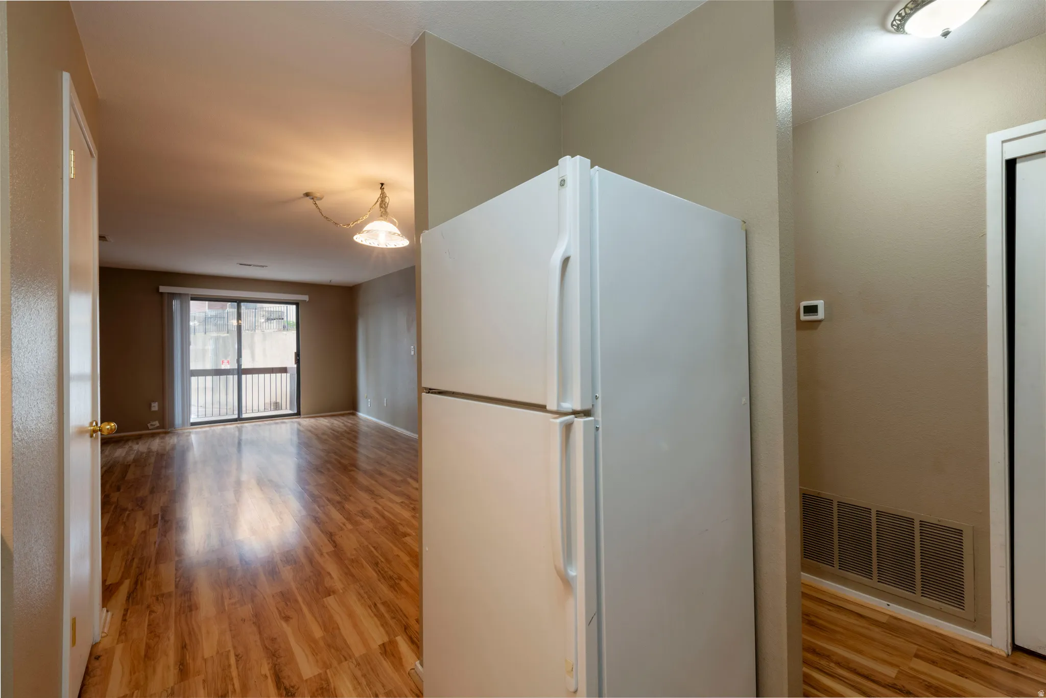 Kitchen featuring freestanding refrigerator and light wood-type flooring