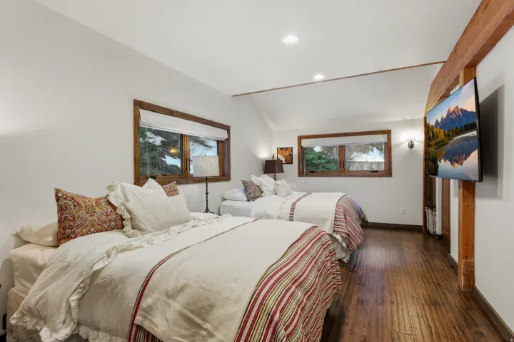 Bedroom with wood-type flooring, vaulted ceiling, and recessed lighting