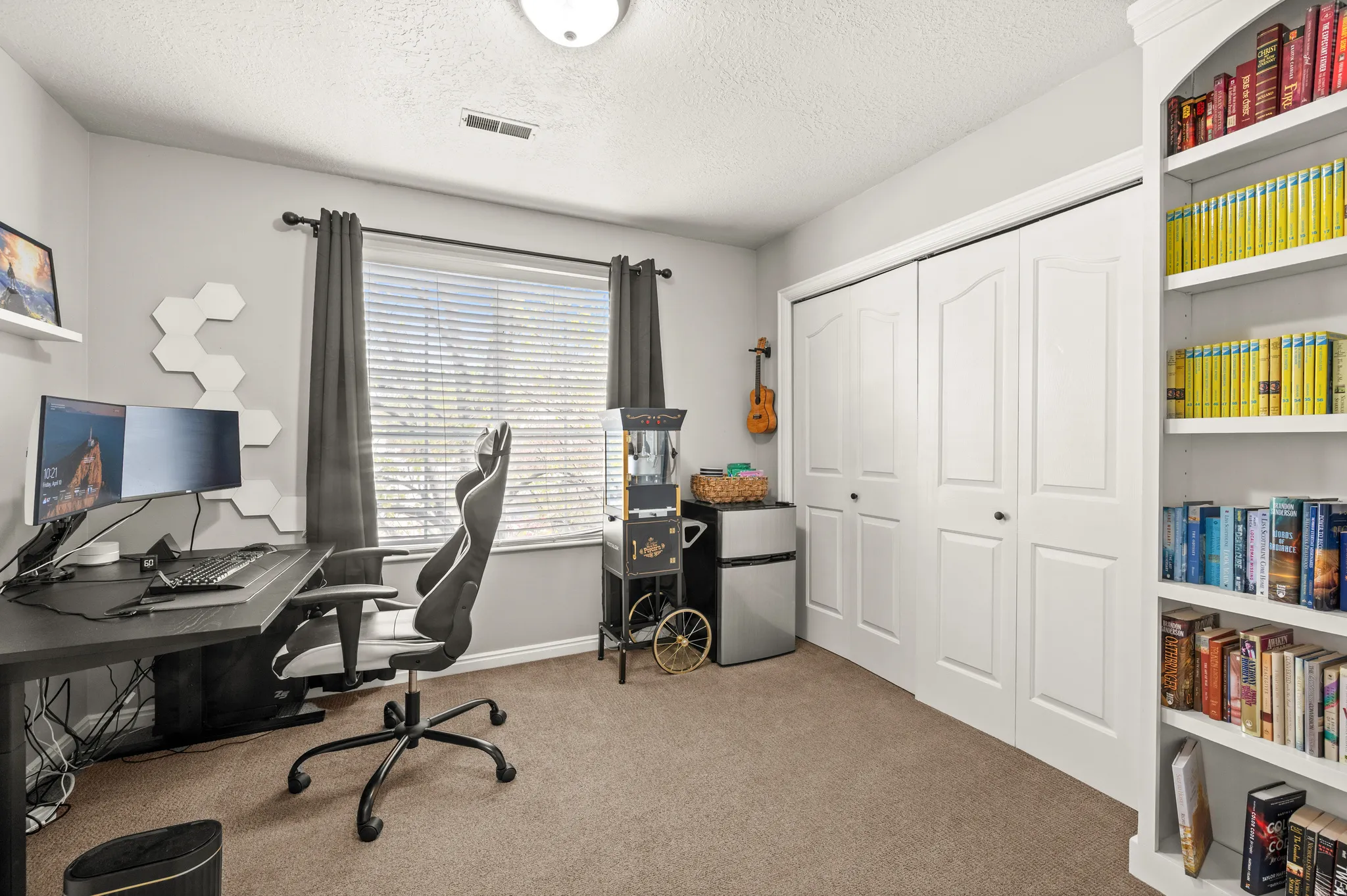 Office area with light carpet and a textured ceiling