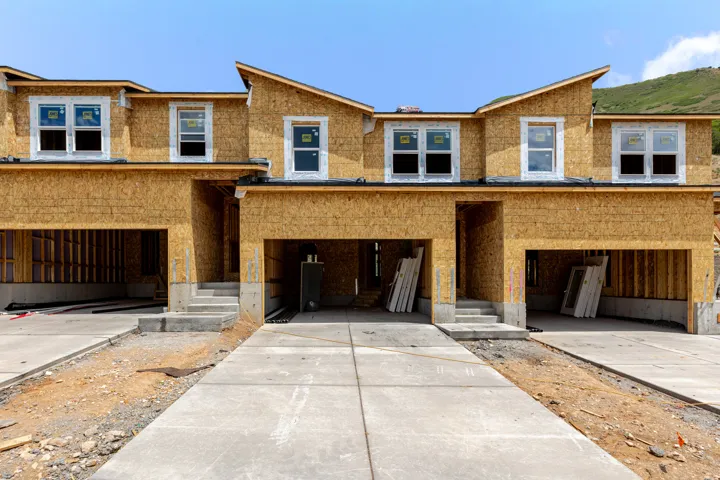 New construction townhome units featuring a contemporary roofline and attached two-car garages