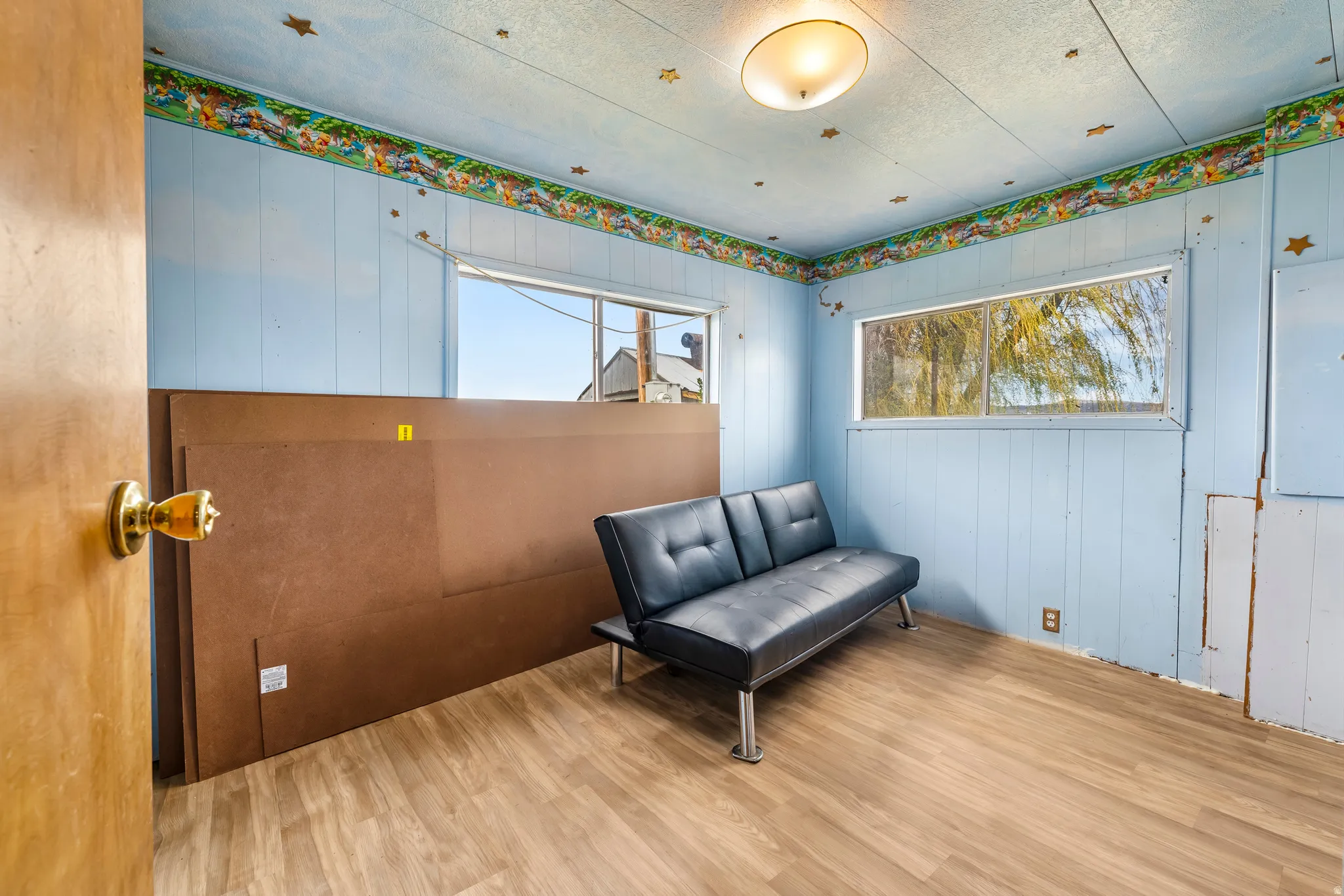 Sitting room with wood finished floors and wooden walls
