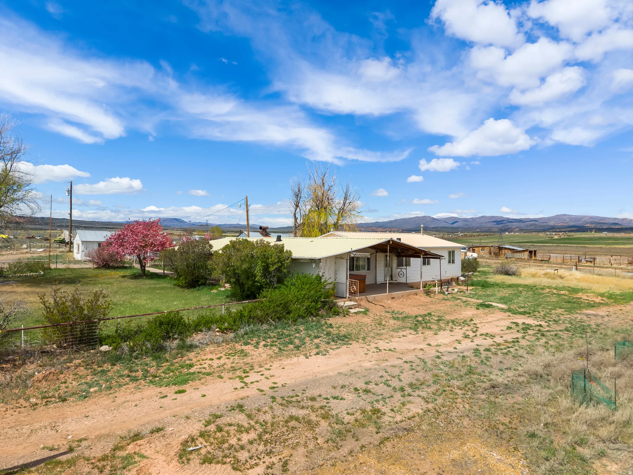 Back of house with a mountain view, a patio, and a view of countryside