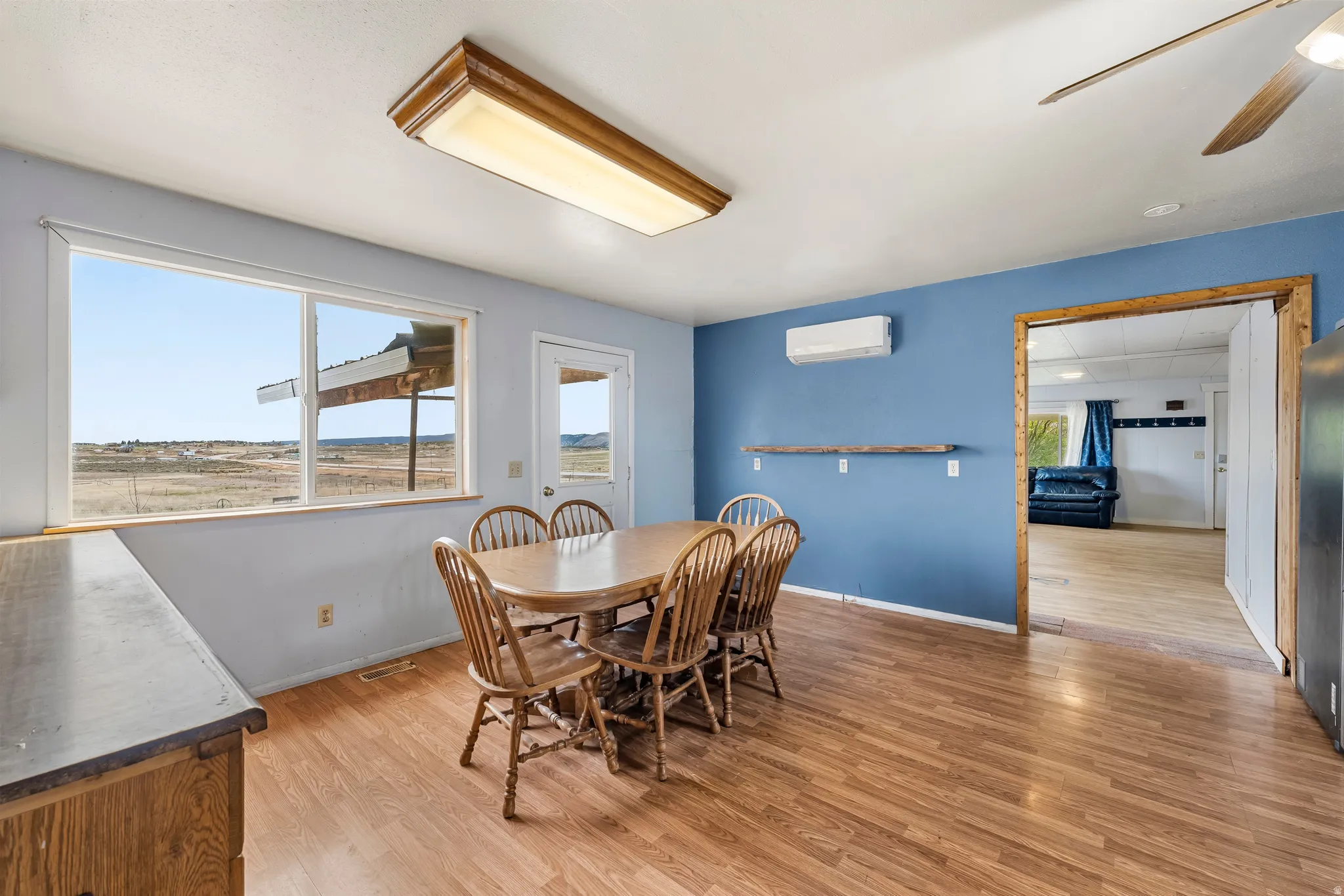 Dining room featuring light wood-style flooring and a ceiling fan