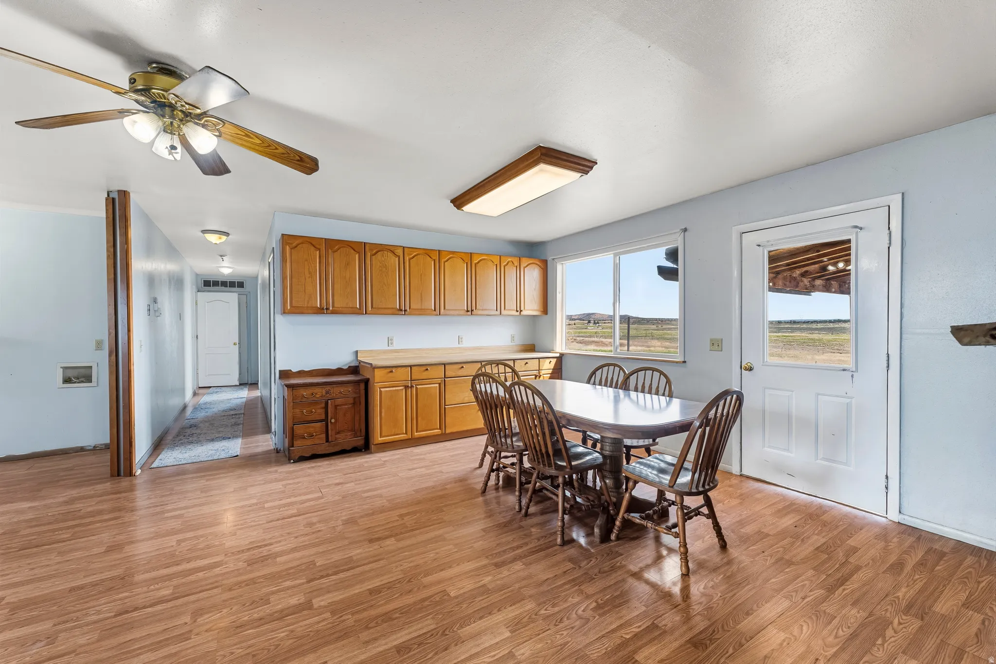 Dining space featuring light wood finished floors and ceiling fan