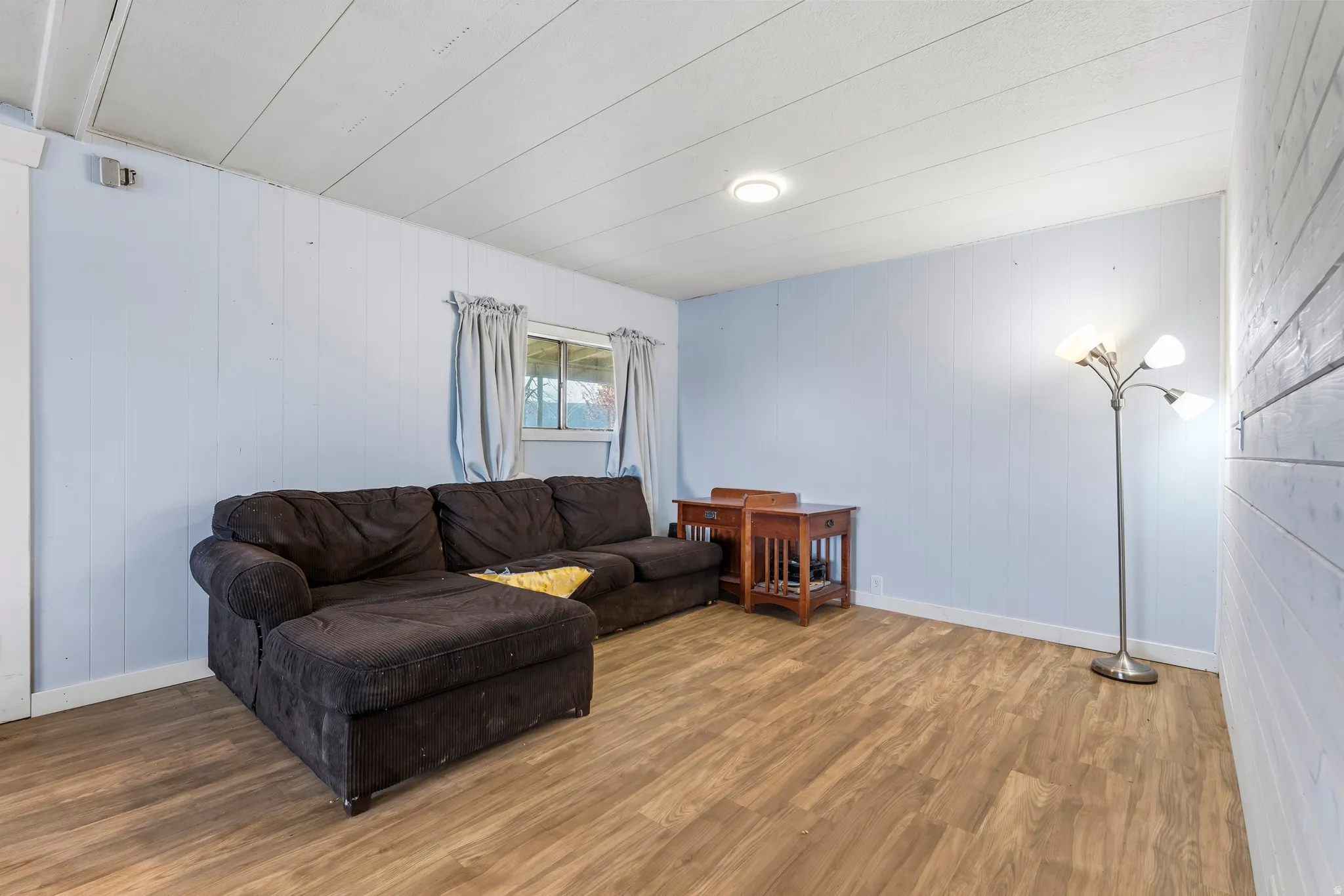 Living area featuring wooden walls and wood finished floors