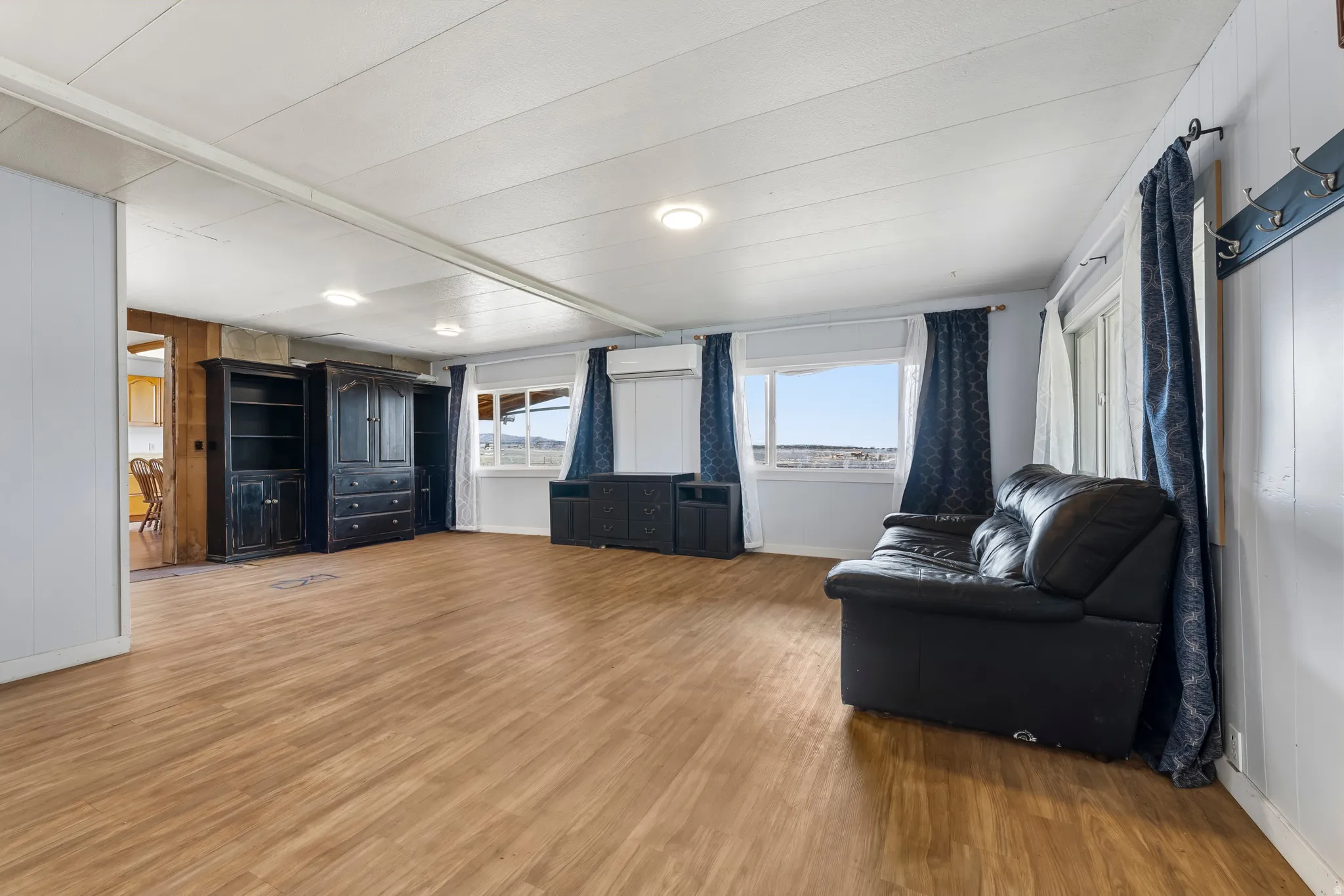 Living area featuring light wood-style flooring and wood walls