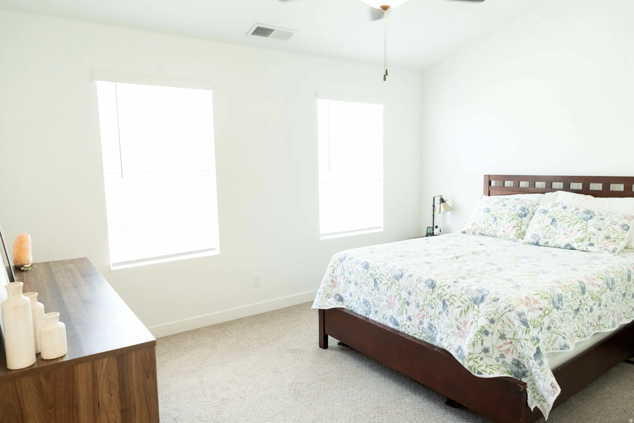 Bedroom with light carpet and ceiling fan