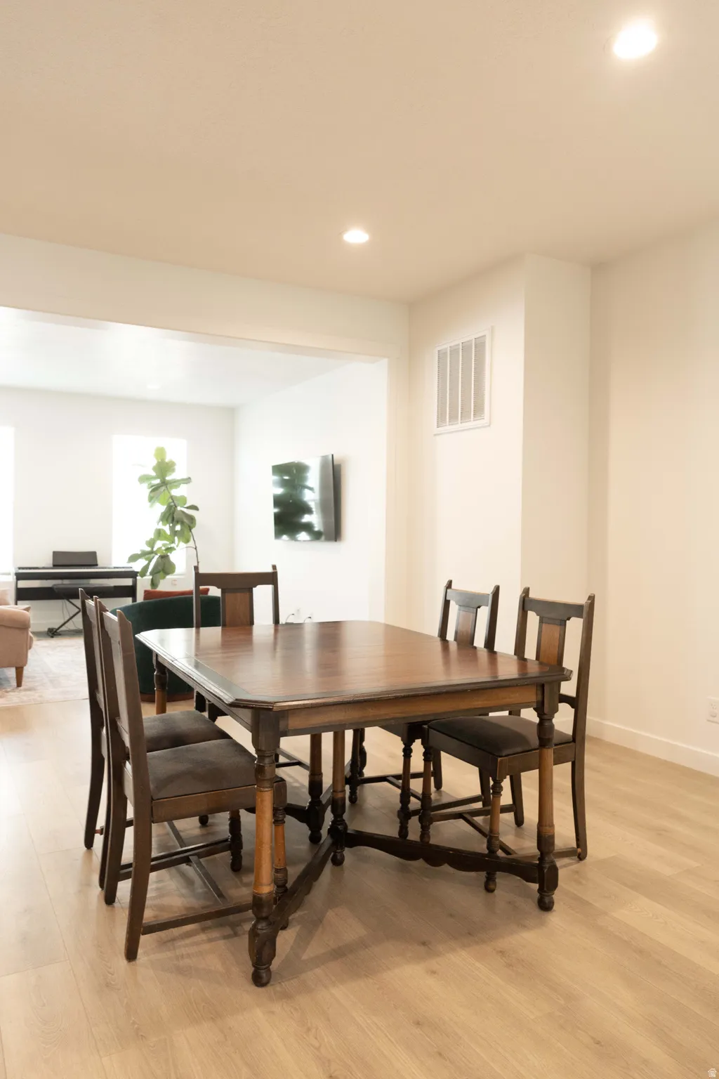 Dining room with recessed lighting and light wood-type flooring