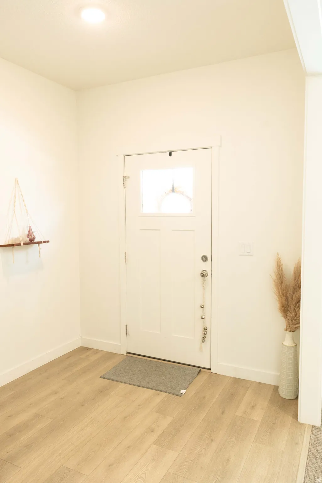 Foyer with light wood-type flooring and baseboards
