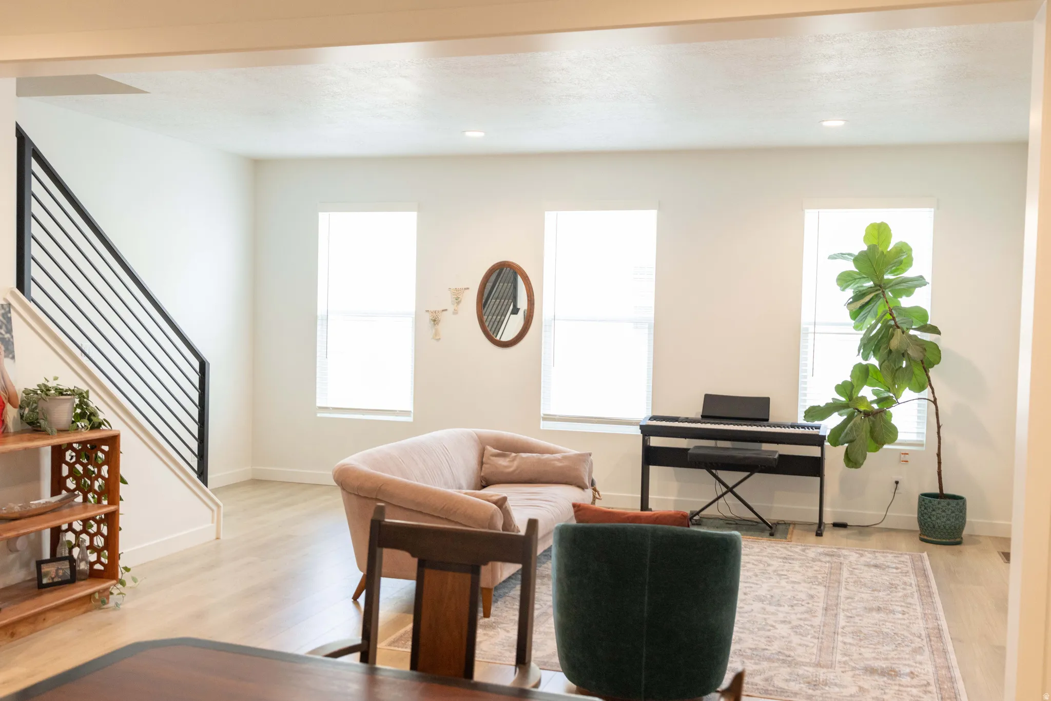 Living area with light wood-type flooring, recessed lighting, and healthy amount of natural light