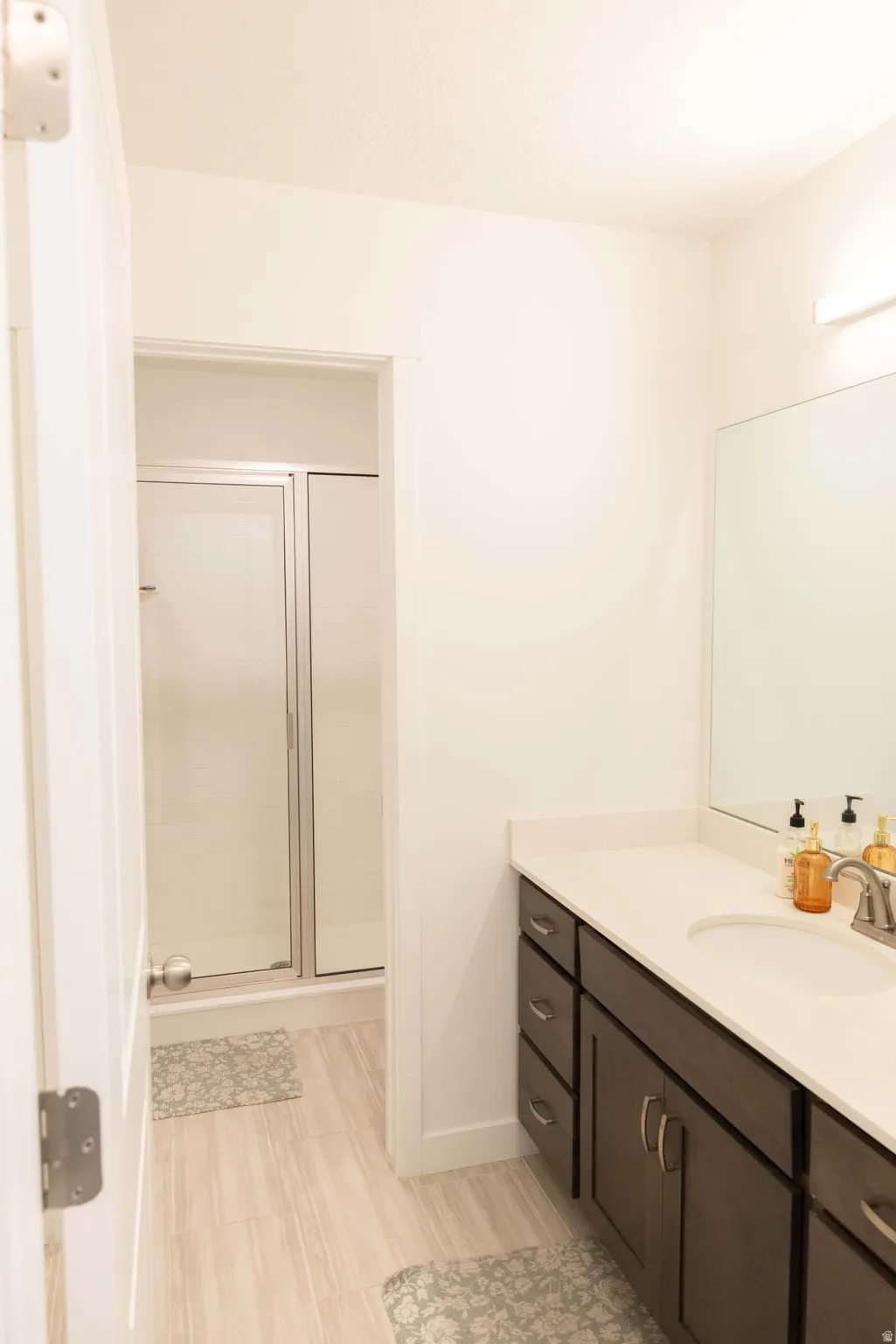 Bathroom with a stall shower and vanity