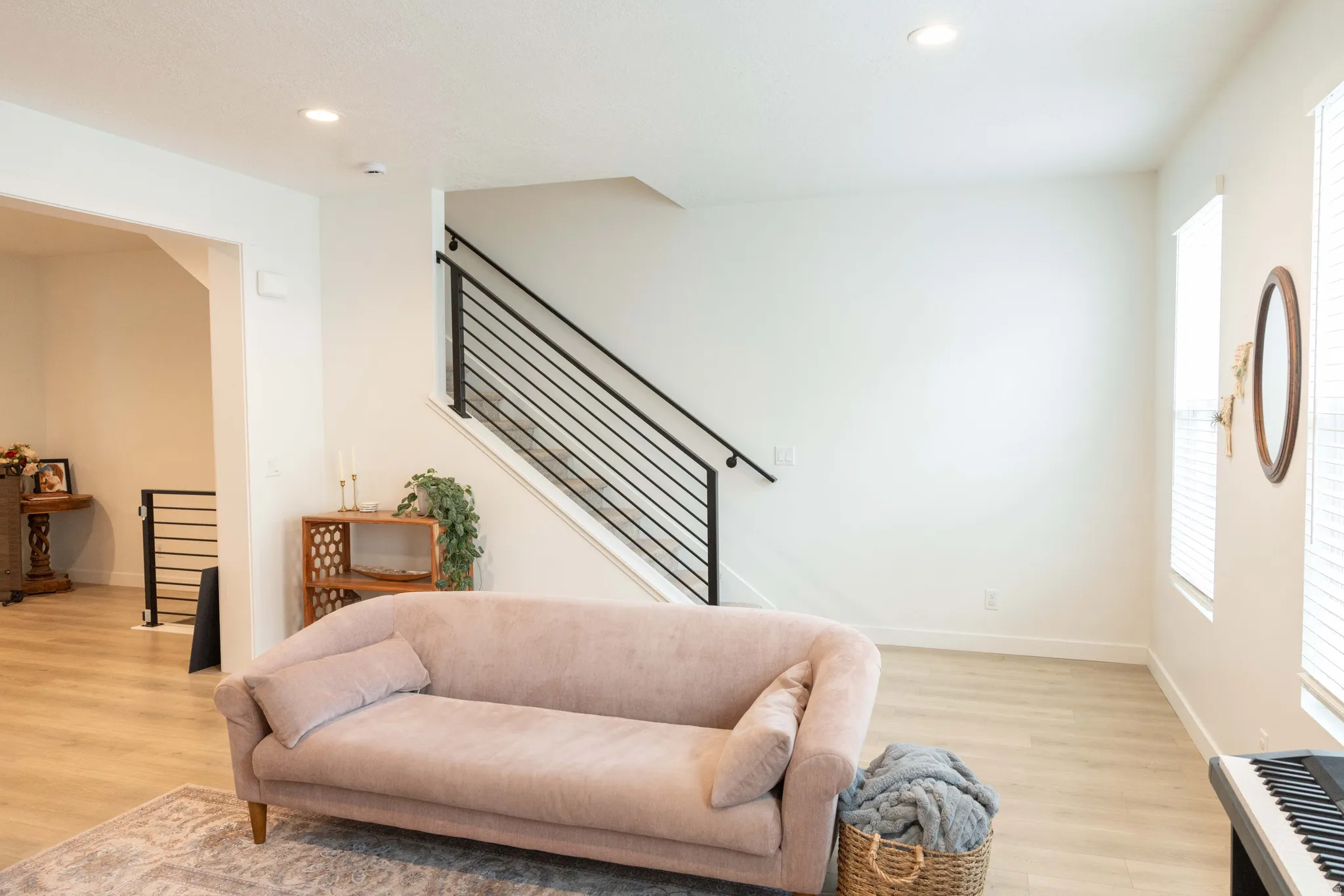 Sitting room with light wood-type flooring and recessed lighting