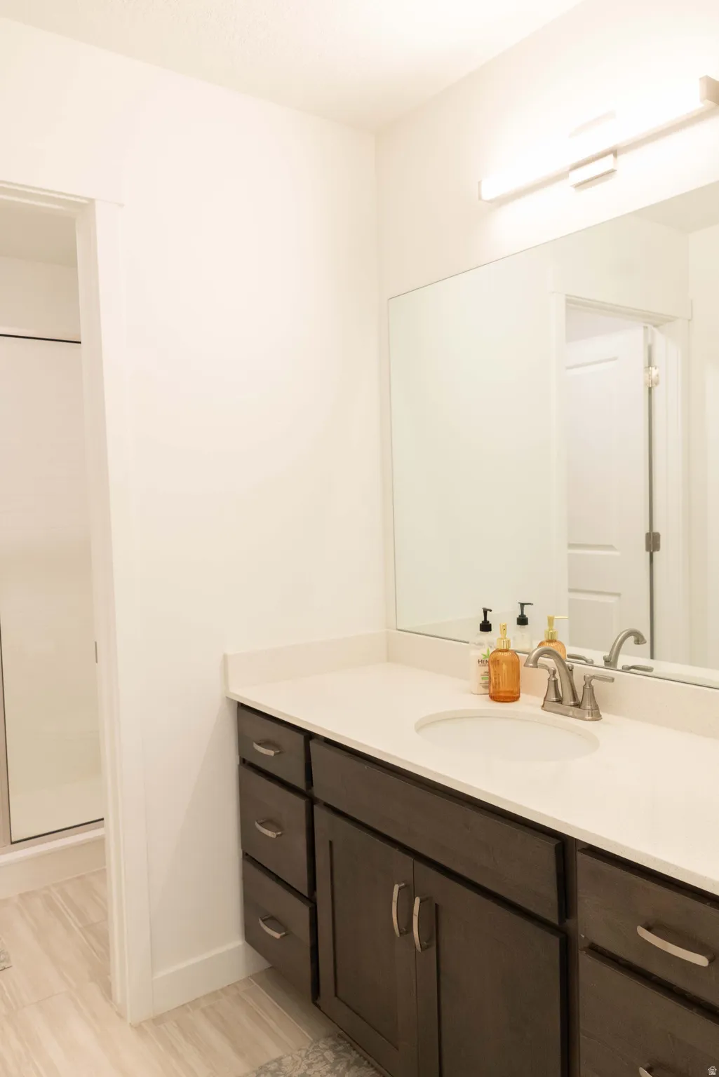 Bathroom with vanity and a shower stall