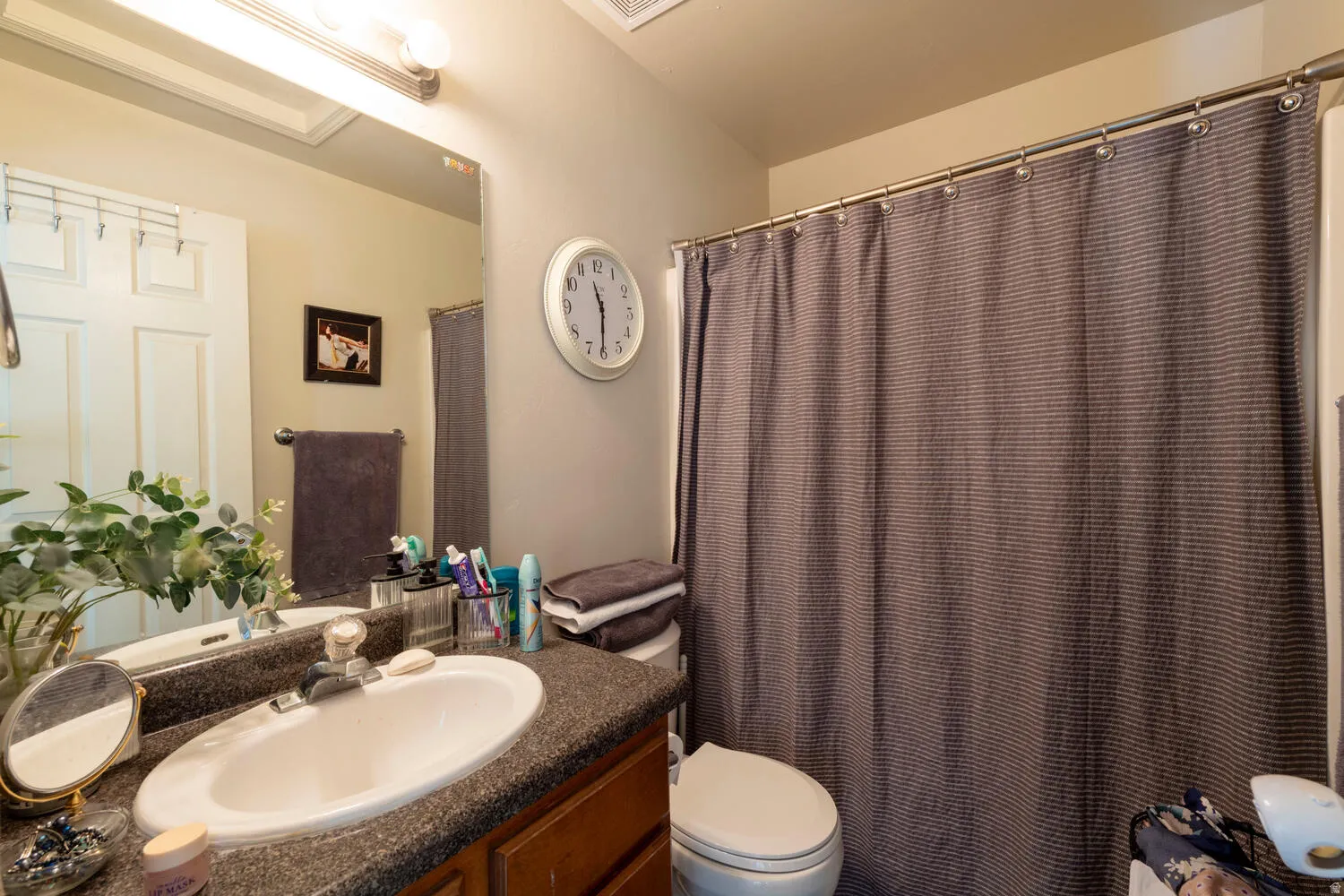 Full bath with vanity and a shower/tub with curtain