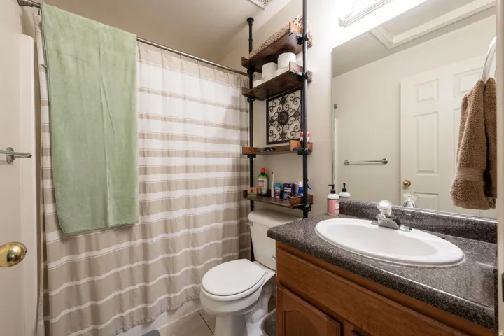 Hall bathroom featuring a shower/tub combo and vanity