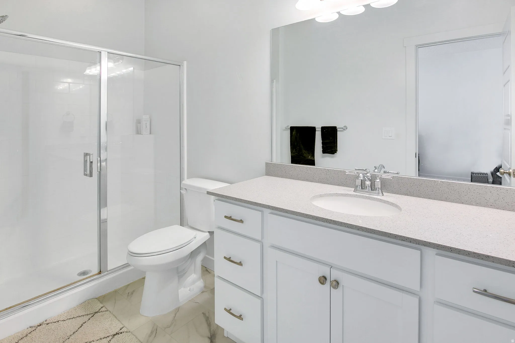 Primary bathroom featuring vanity and a stall shower