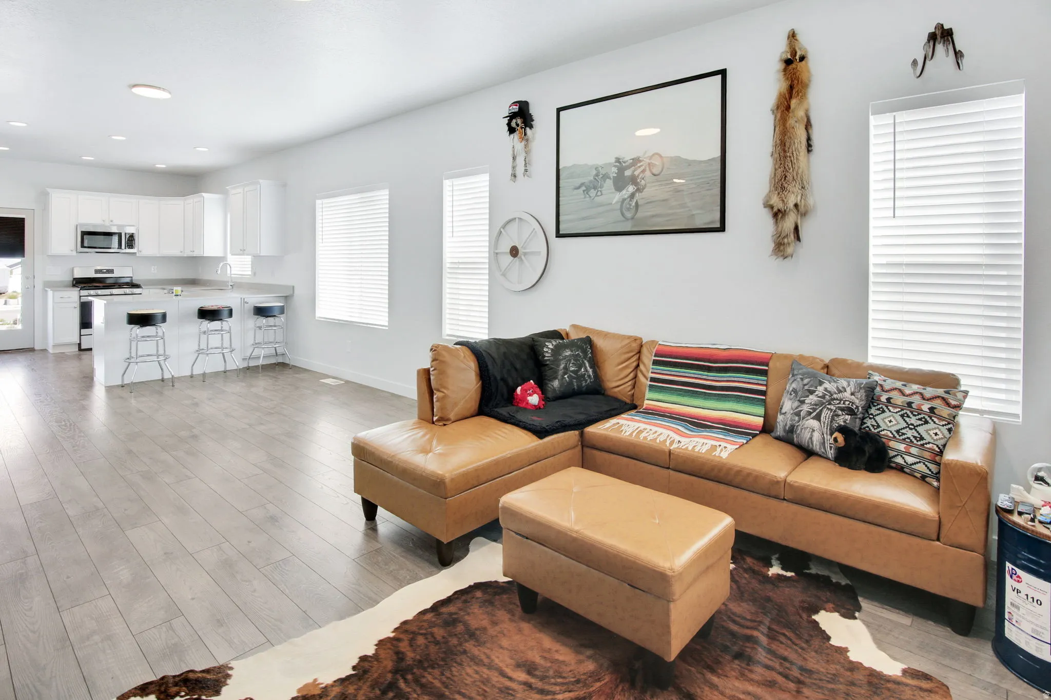 Living room with light wood finished floors, recessed lighting, and healthy amount of natural light
