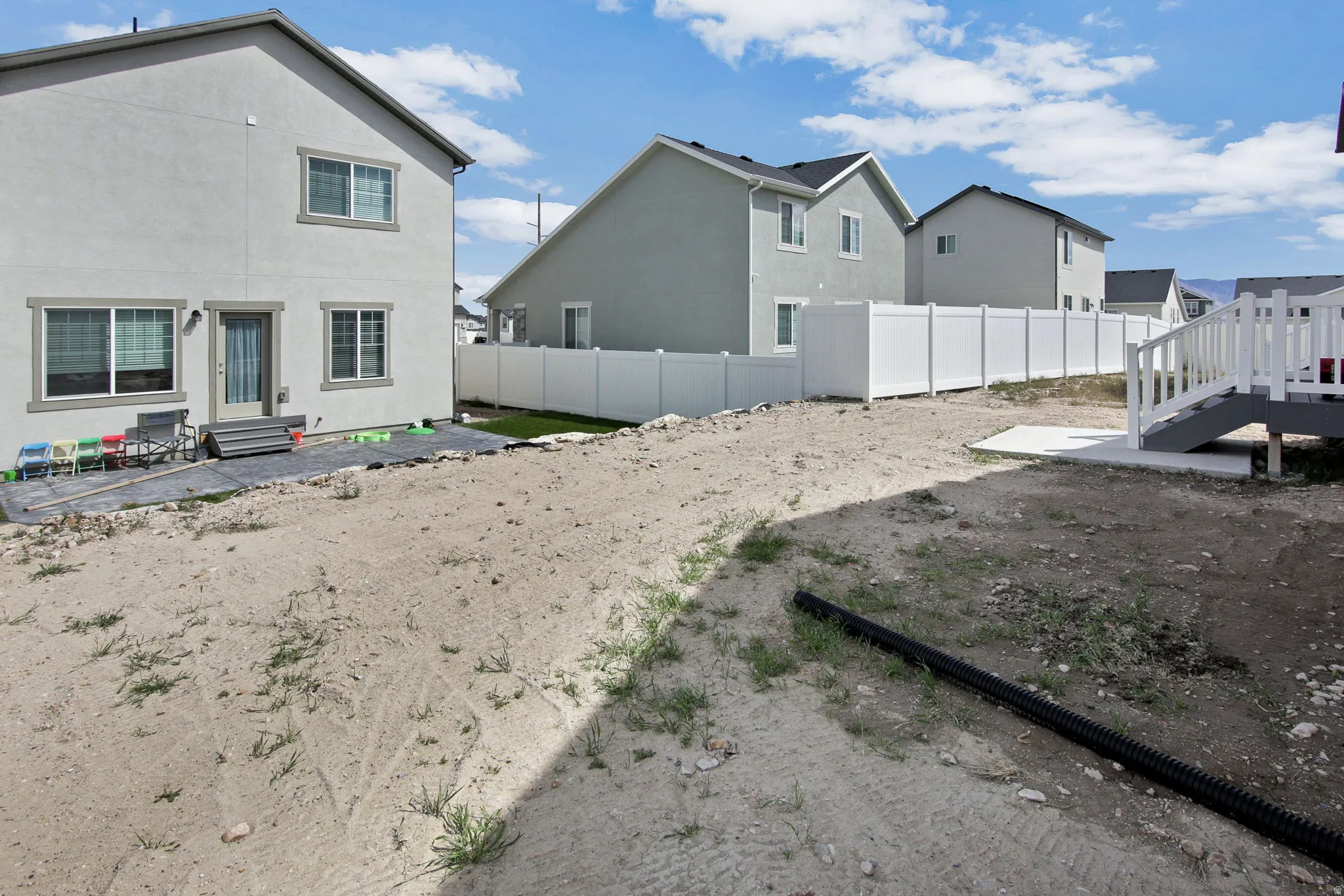 Fenced yard with a patio, entry steps, and a residential view