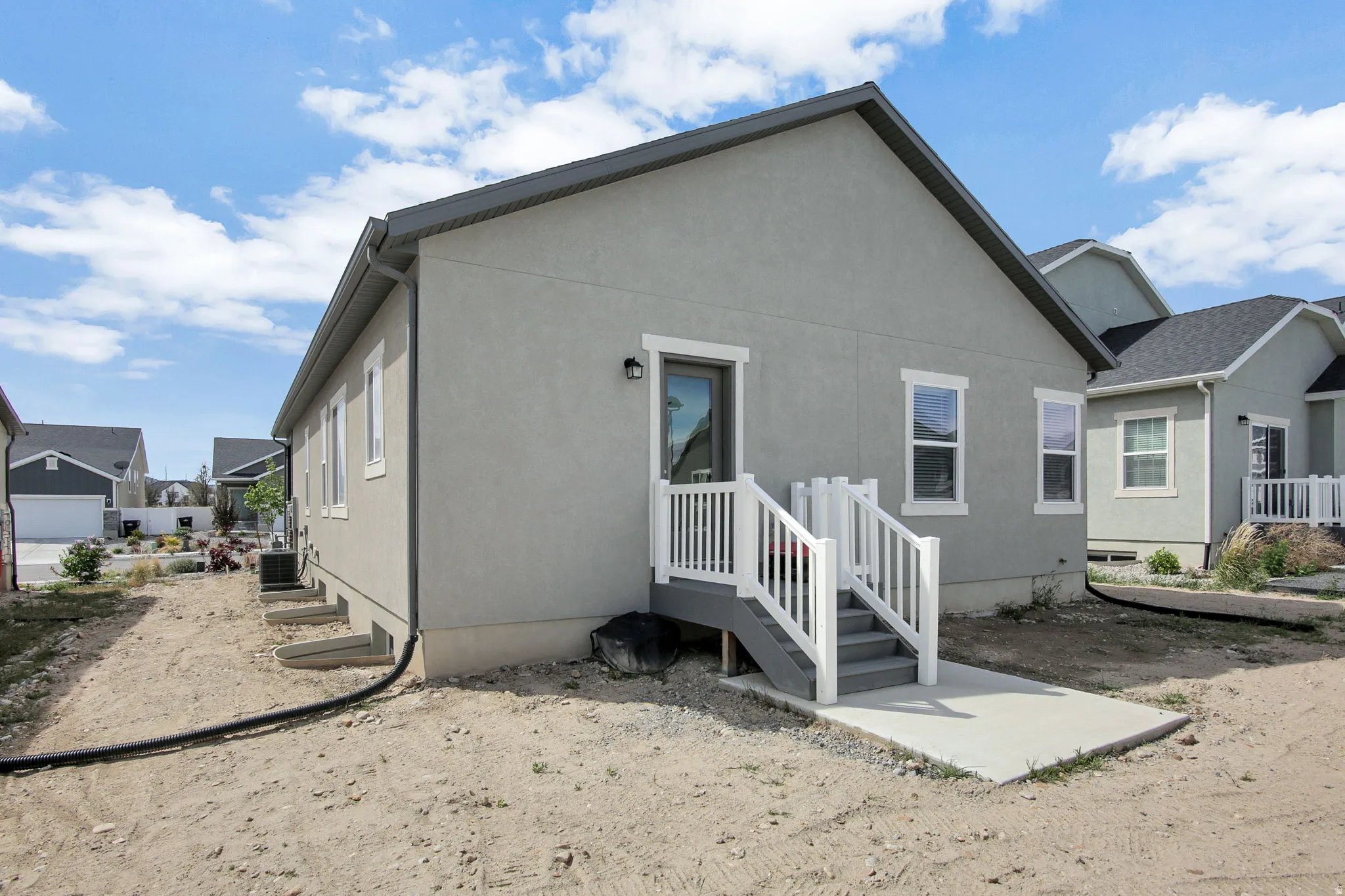 Back of house featuring stucco siding