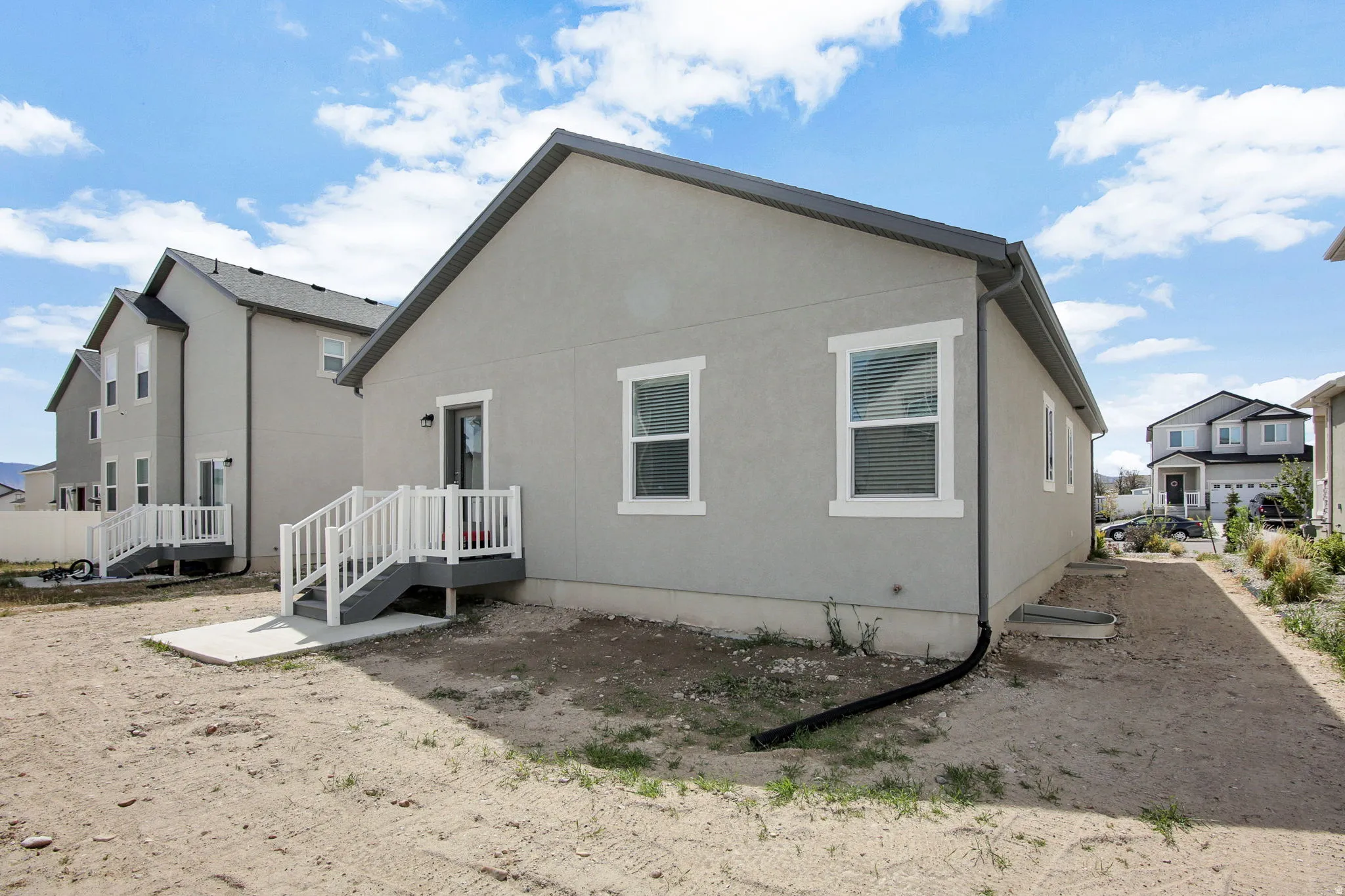 Rear view of house featuring stucco siding