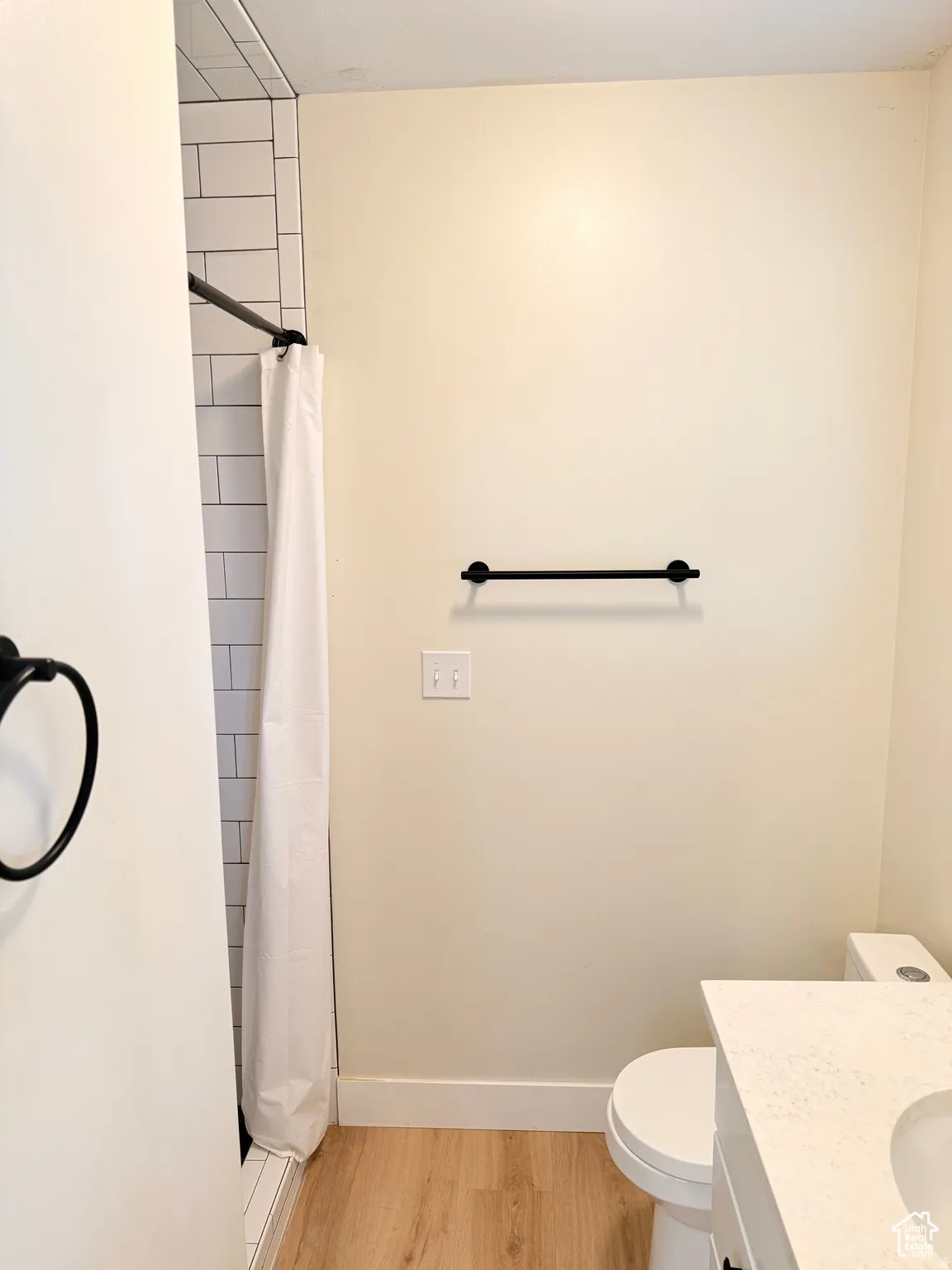 Bathroom featuring vanity, a shower stall, and light wood finished floors