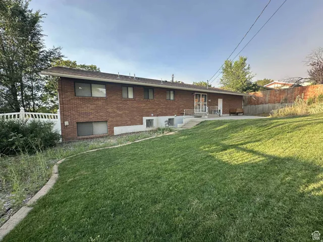 Back of property featuring brick siding and a patio