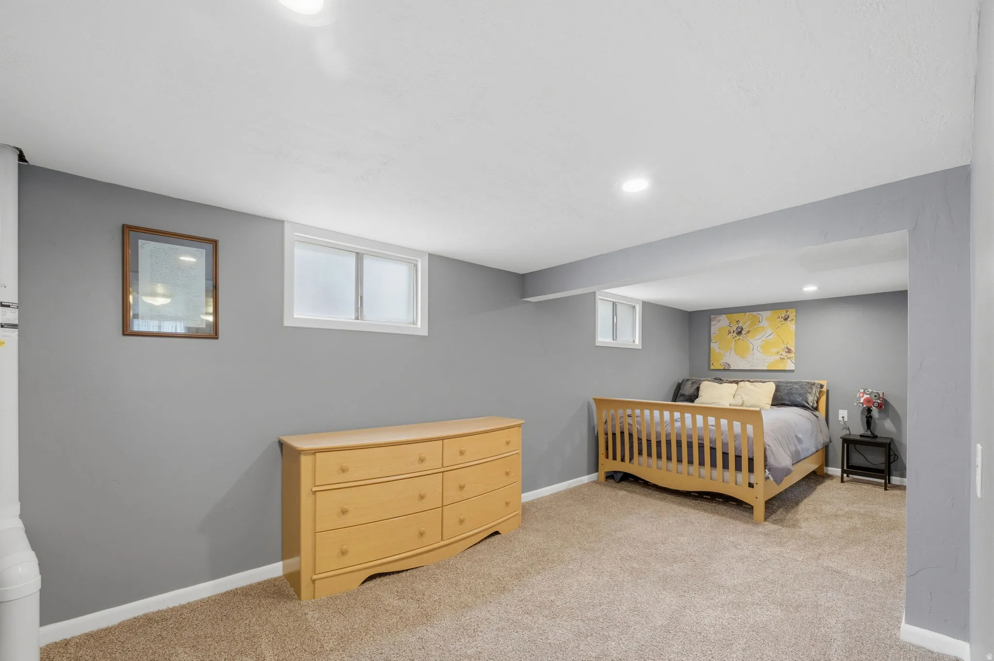 Bedroom featuring light colored carpet, multiple windows, and recessed lighting