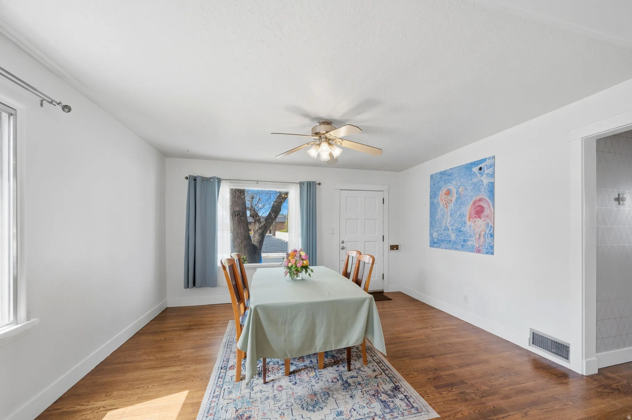 Dining or living space featuring a ceiling fan and wood finished floors