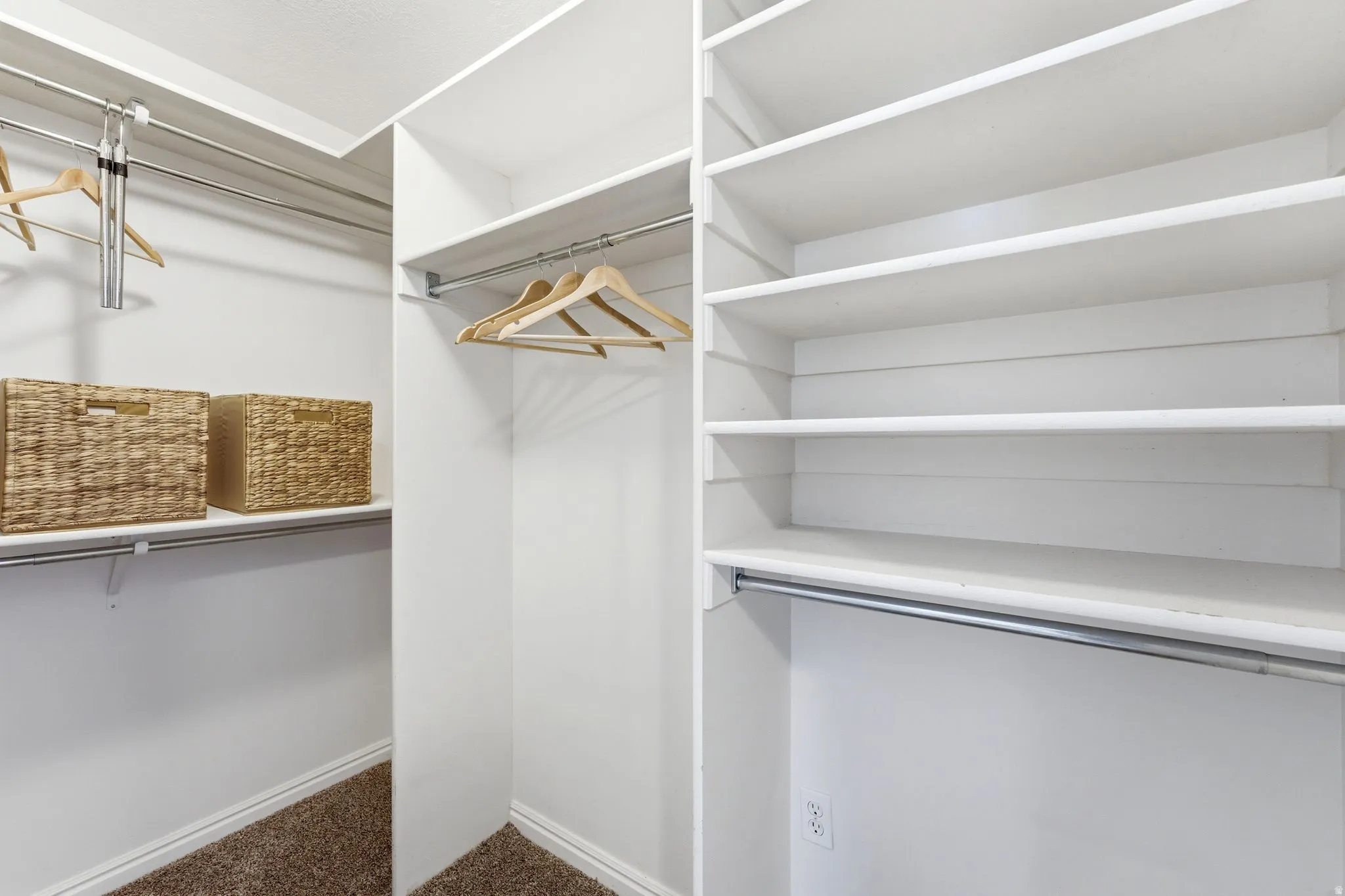 Walk in closet with dark carpet