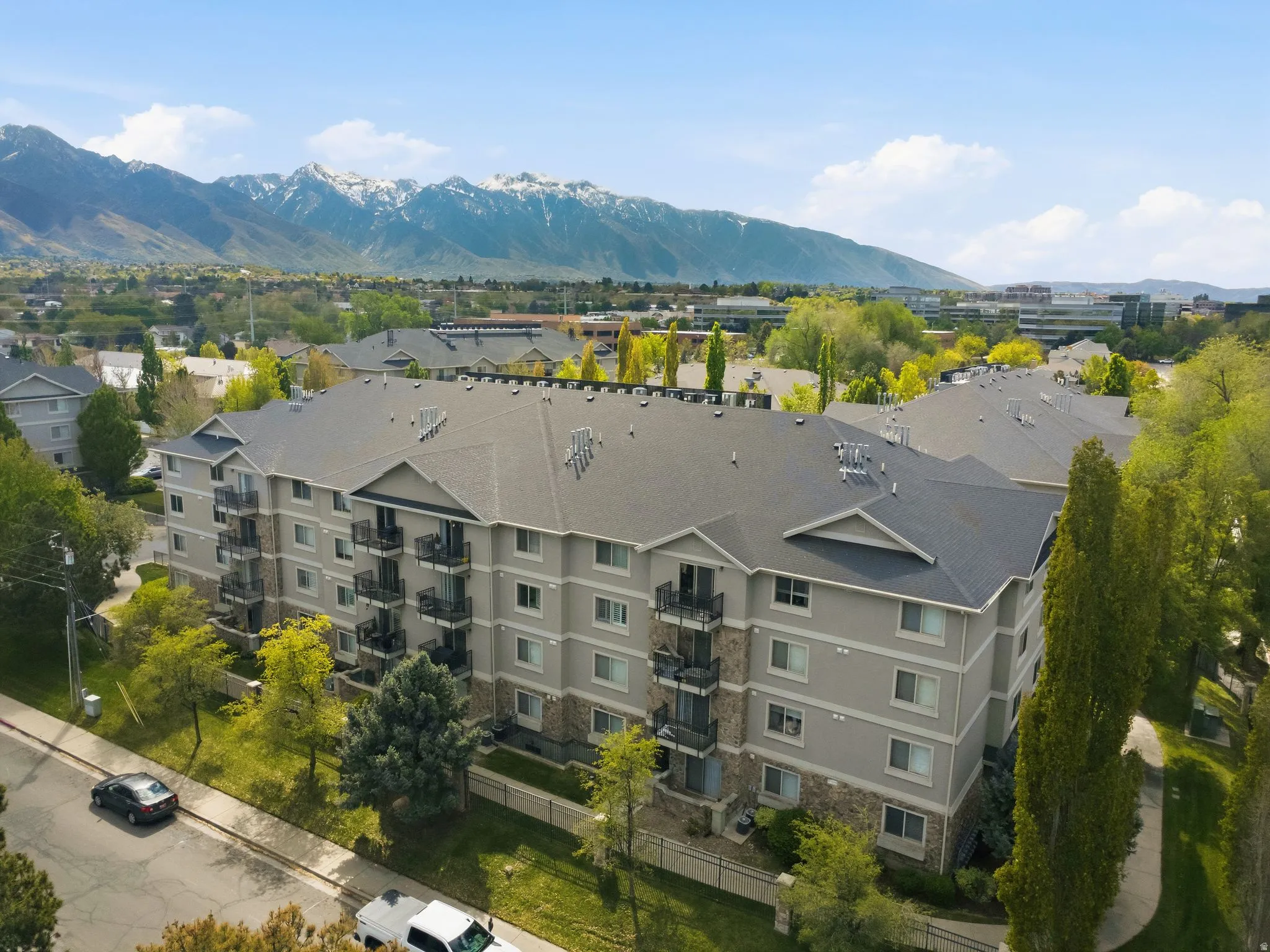 Aerial view of a mountainous background and apartment complex / building