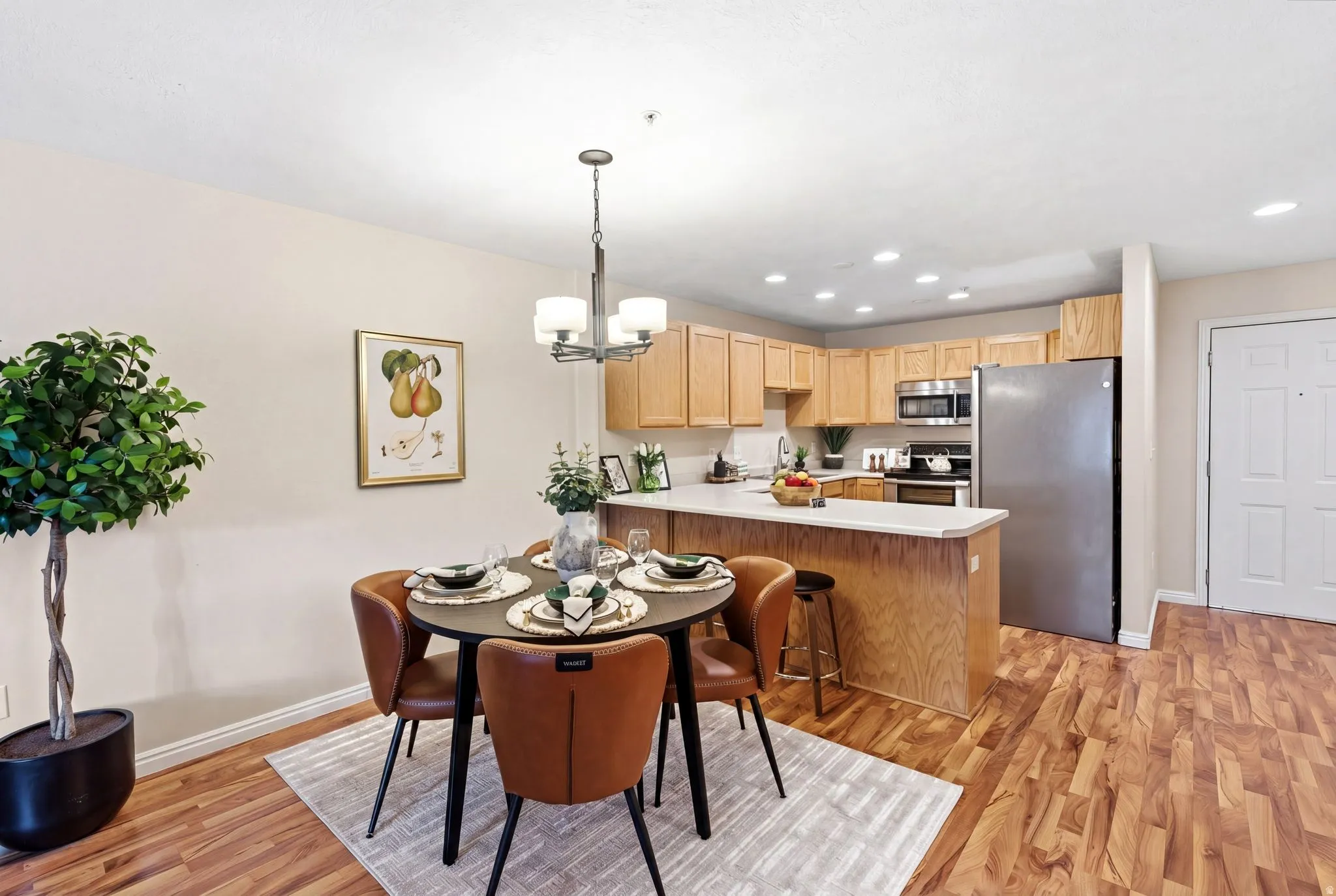 Dining room featuring light wood-type flooring and hanging lights