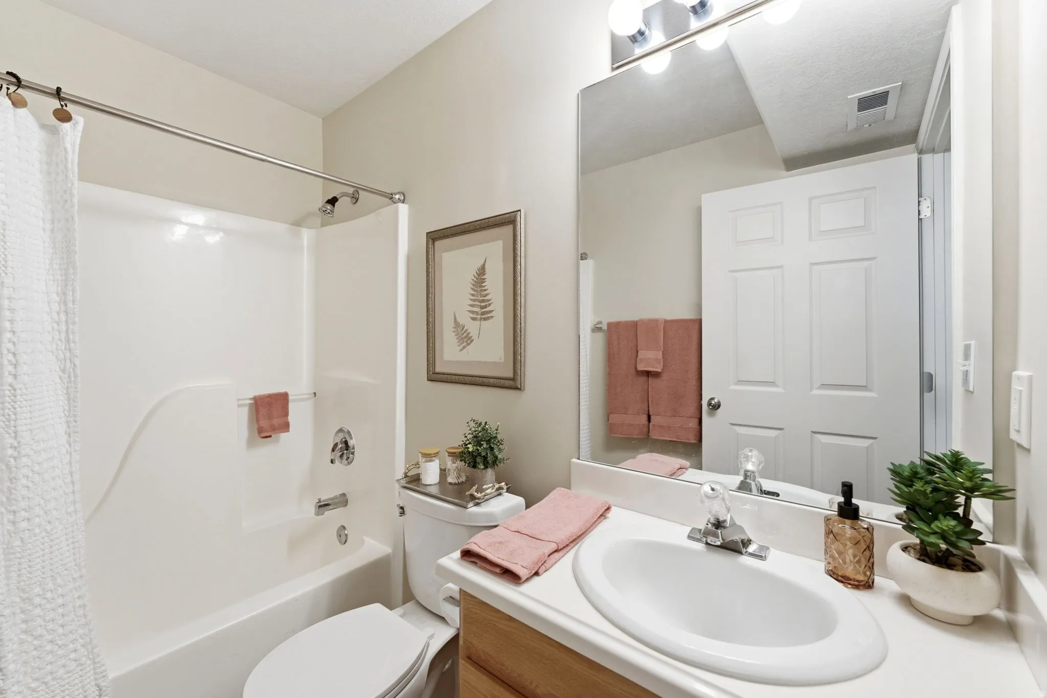 Bathroom with vanity and shower / tub combo