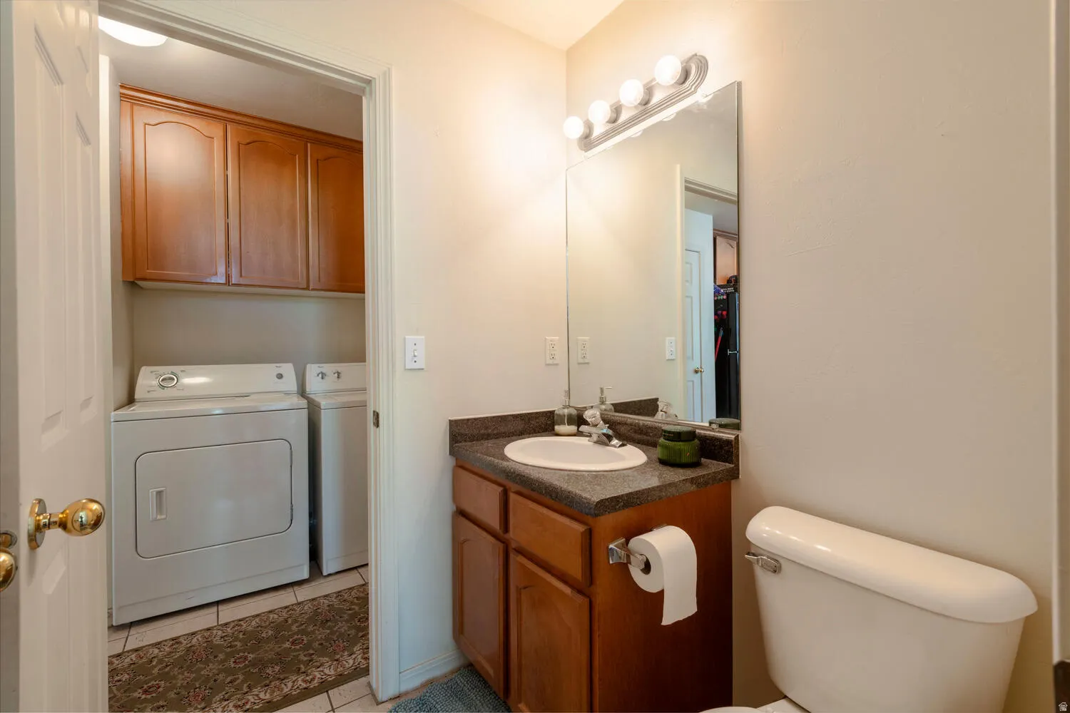 Half bathroom featuring vanity and seperate laundry