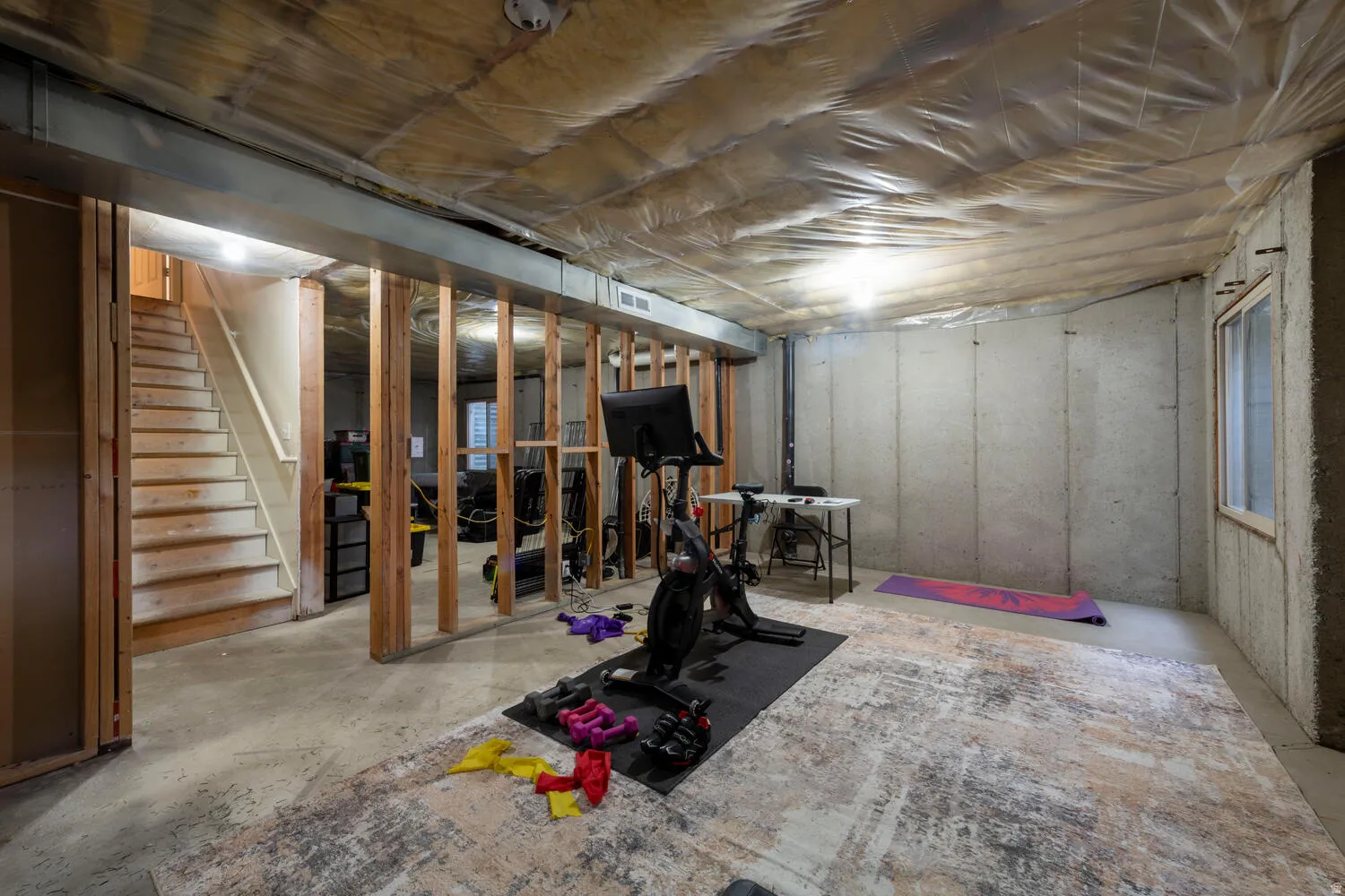 Unfinished basement featuring stairway to main floor