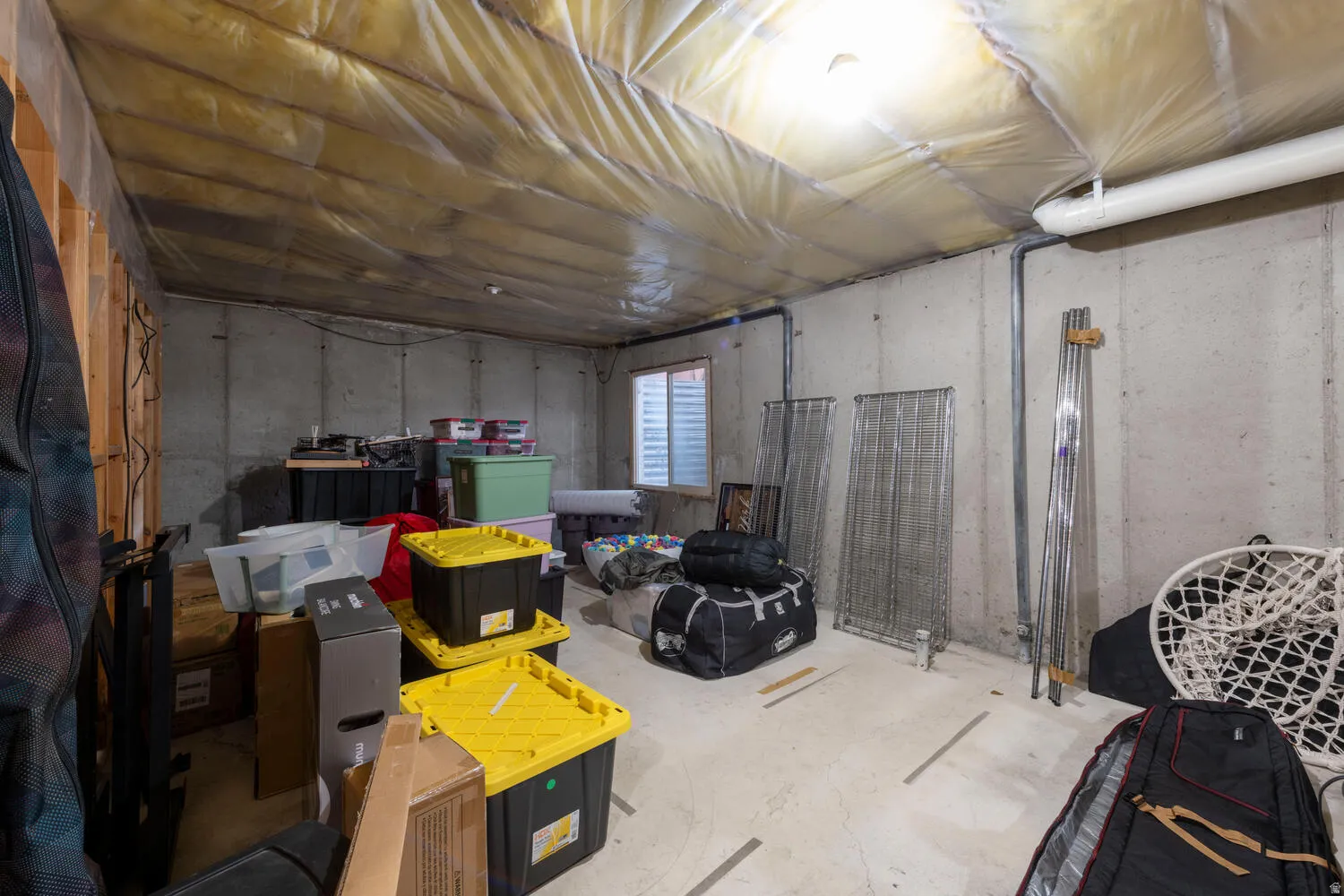 View of unfinished basement storage