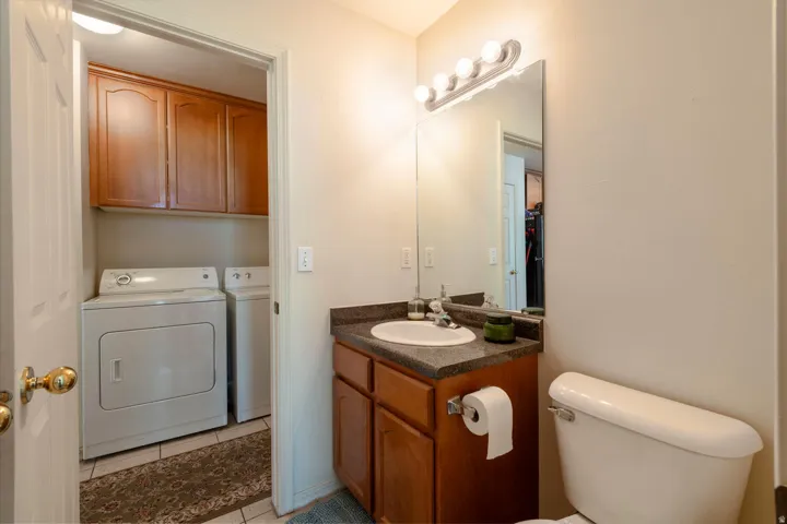 Half bathroom featuring vanity and seperate laundry