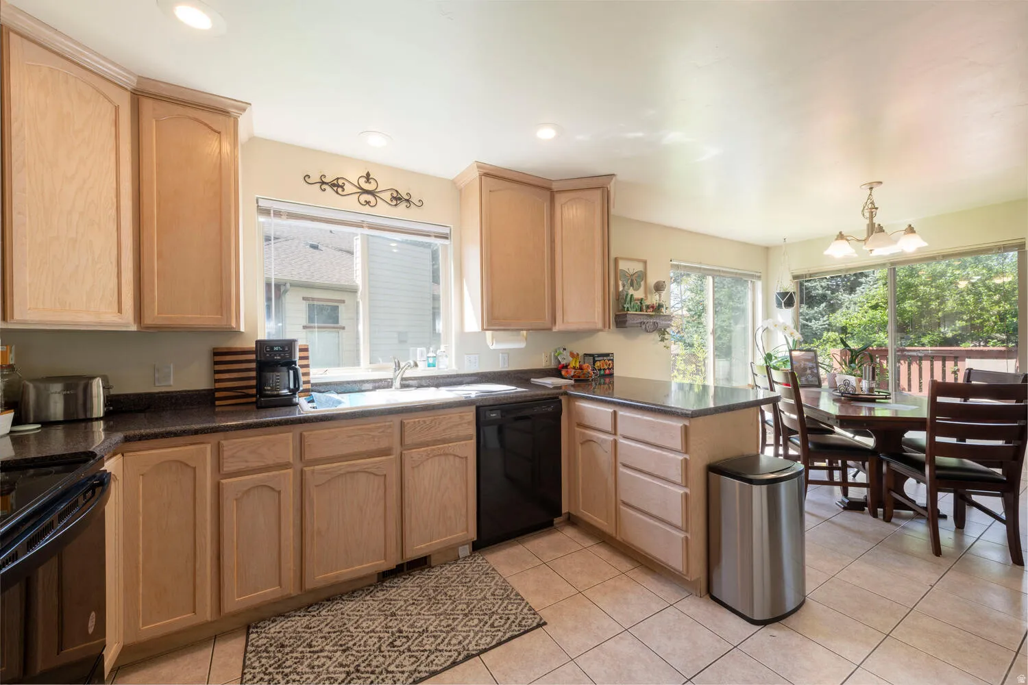 Kitchen with dining area and in the background a view of the outside deck