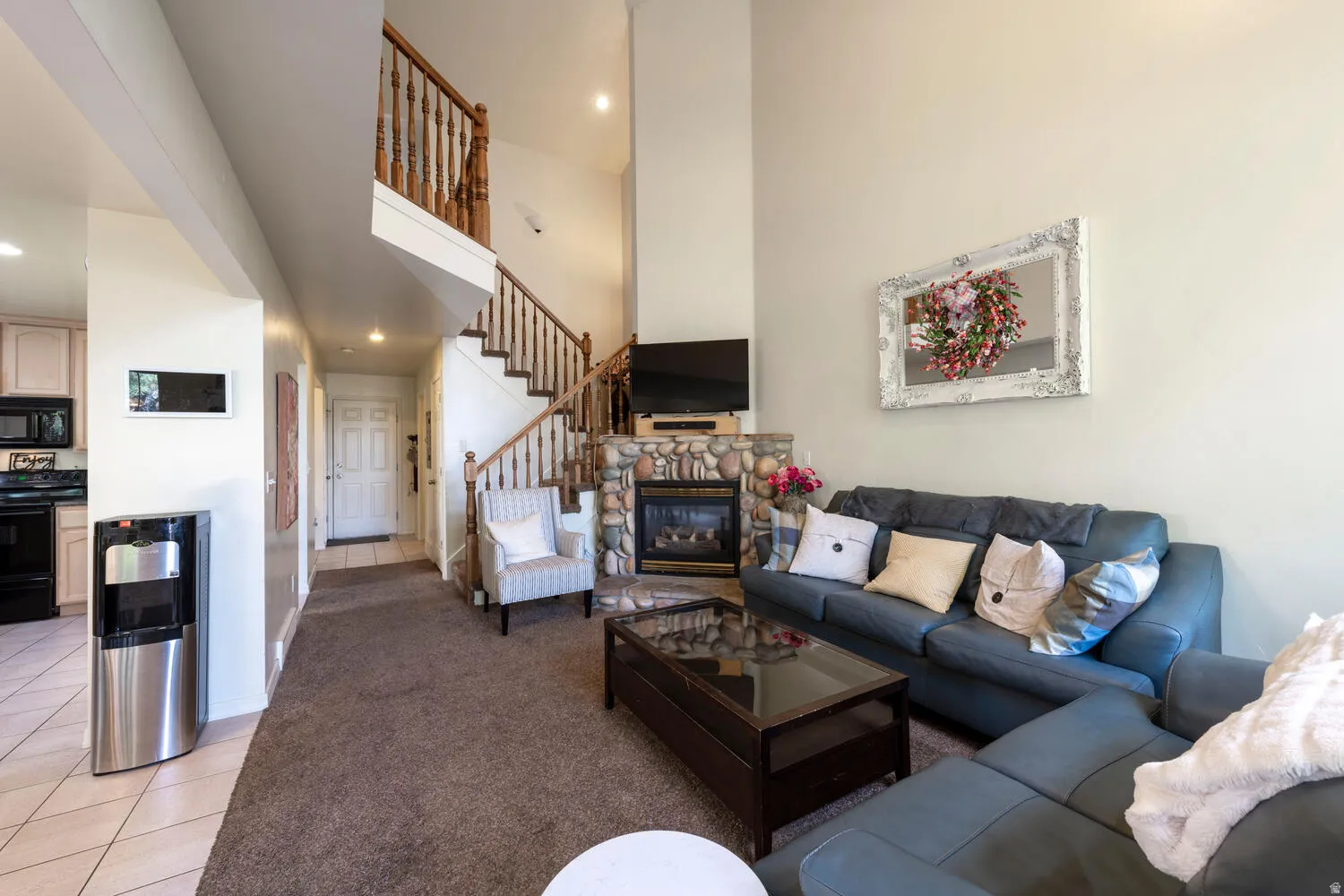 Living area with view of dining area and staircase in the background